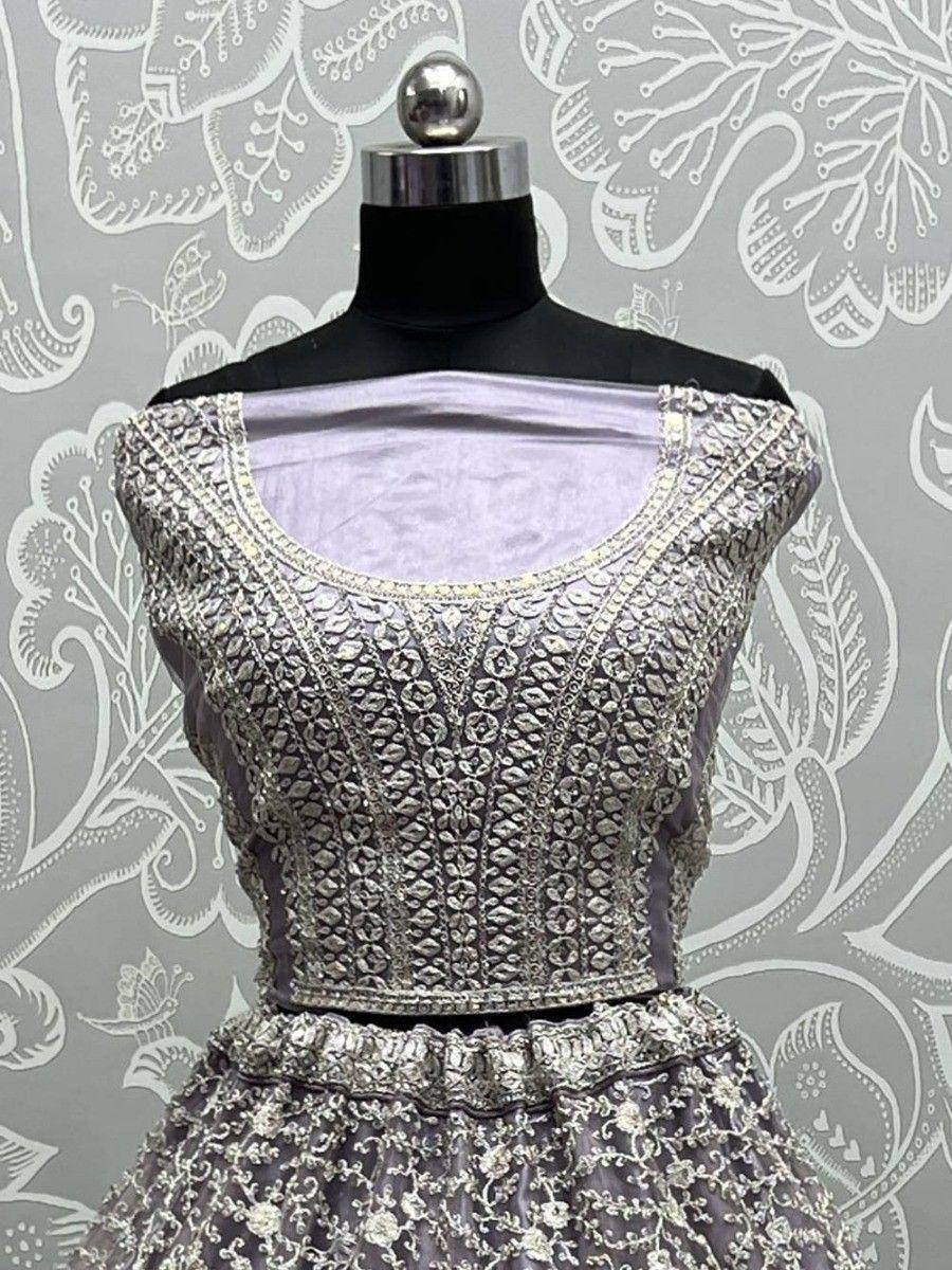 Lavish silver-embroidered lehenga choli with off-shoulder blouse, perfect for Indian weddings and festive occasions.