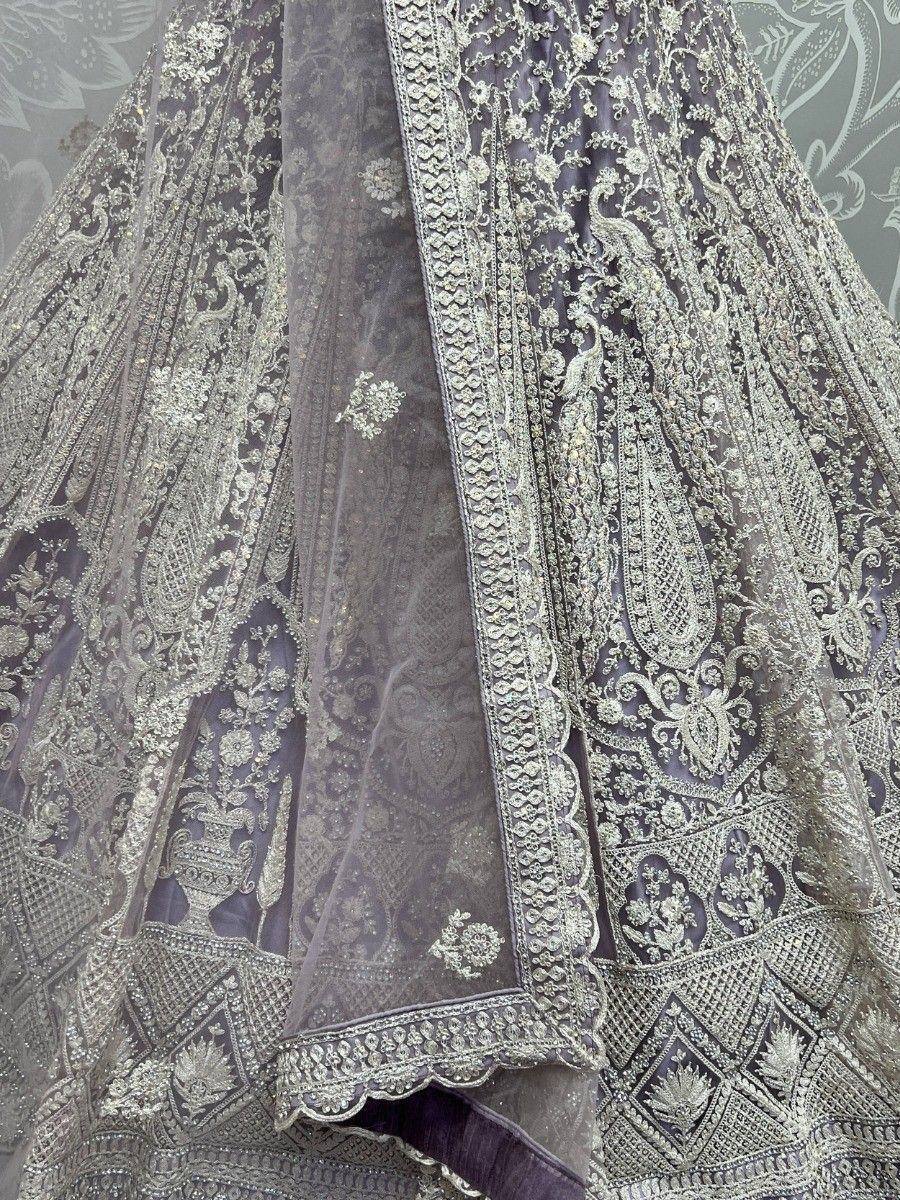 Grey designer lehenga with intricate silver embroidery and peacock motifs, perfect for Indian ethnic wear.