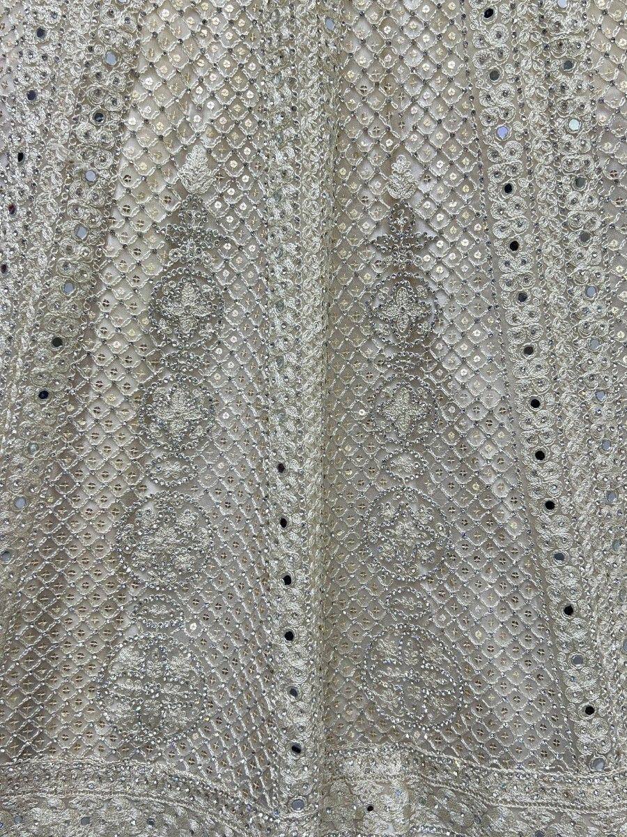 Elegant silver ethnic wear with intricate mirror and bead embroidery, perfect for festive occasions.