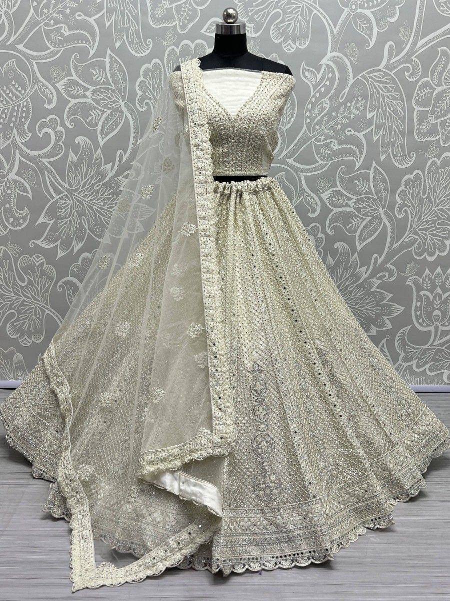Elegant ivory lehenga choli with intricate embroidery and sequin work, perfect for Indian weddings and festive occasions.