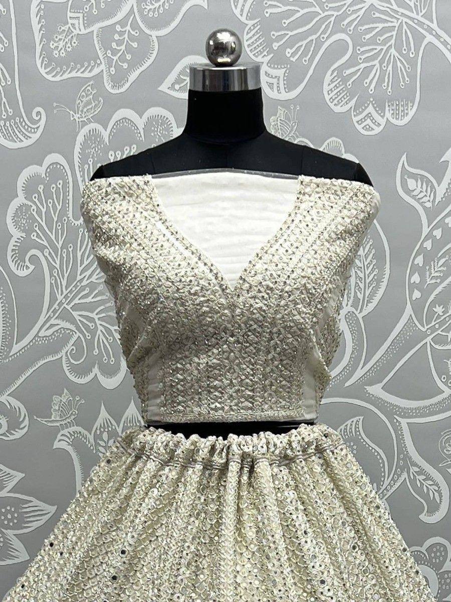 Elegant off-shoulder sequin lehenga choli with V-neck blouse, perfect for weddings and festive occasions
