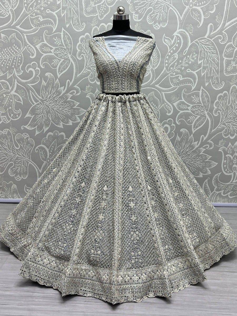 Elegant silver embroidered lehenga choli with intricate floral patterns, perfect for Indian ethnic wear occasions.