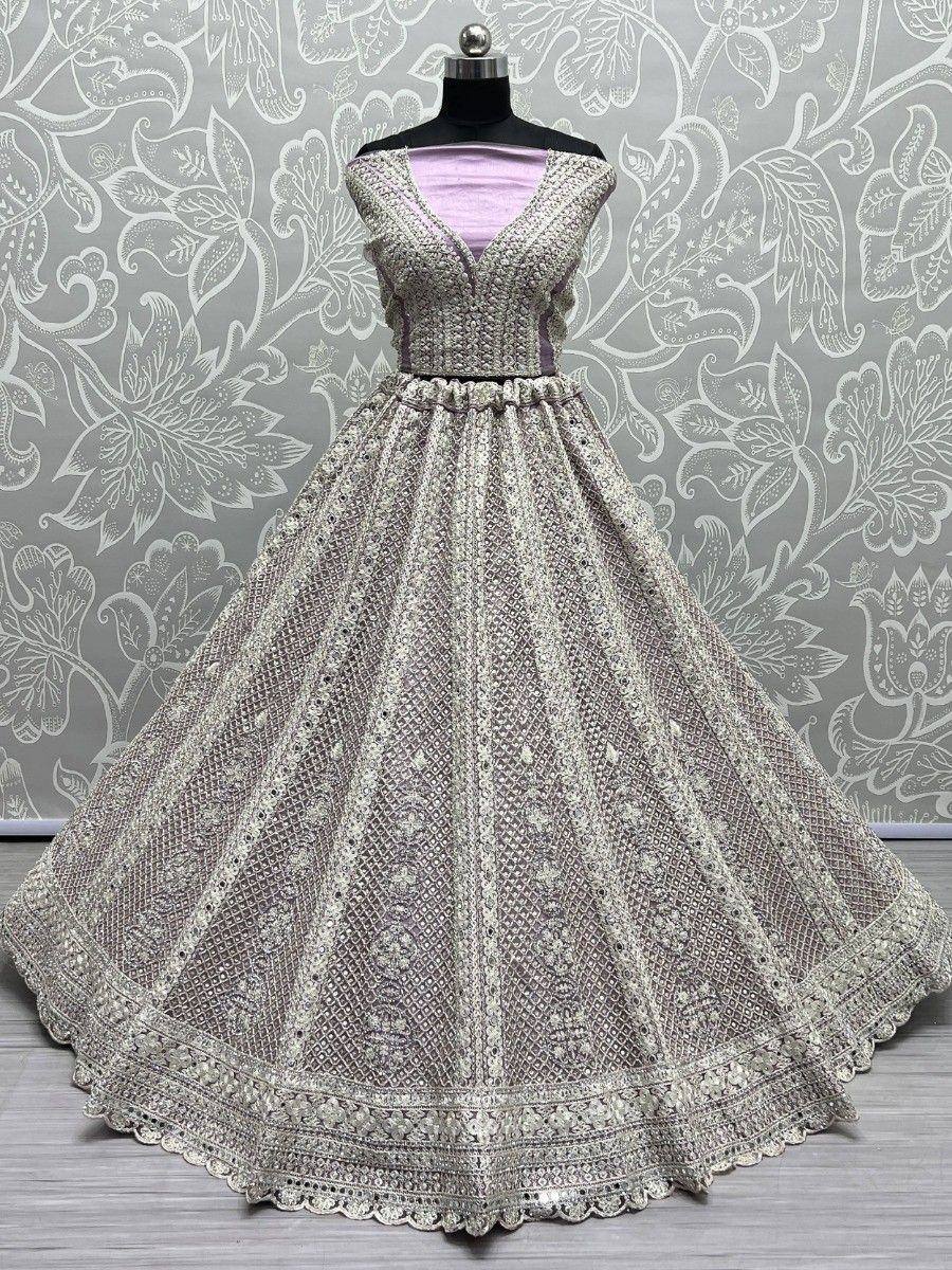 Elegant silver embroidered lehenga choli with intricate net work and scalloped hem, perfect for Indian ethnic occasions.