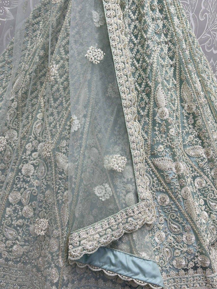 Elegant mint green lehenga choli with intricate silver embroidery and lace detailing, perfect for Indian ethnic wear.