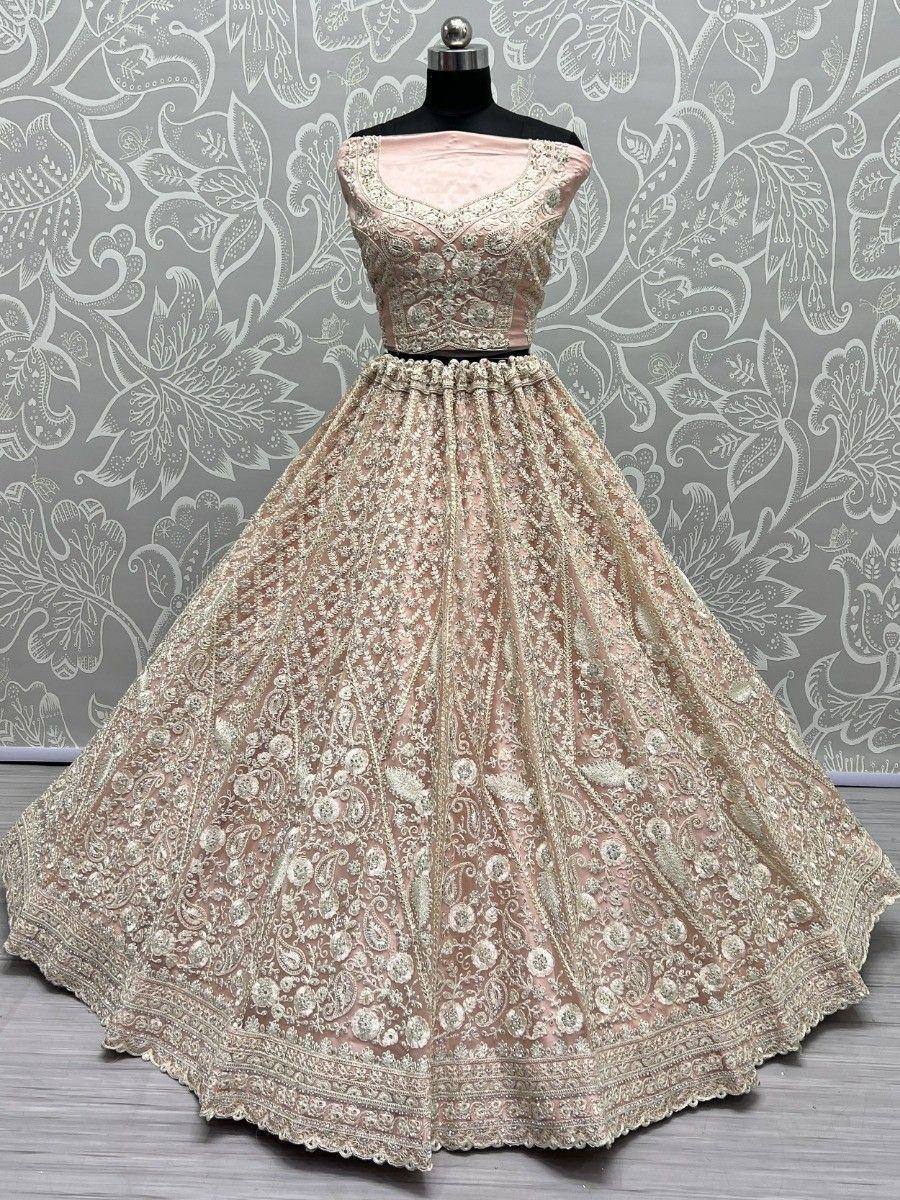 Pink designer lehenga choli with intricate gold embroidery, perfect for weddings and festive occasions.