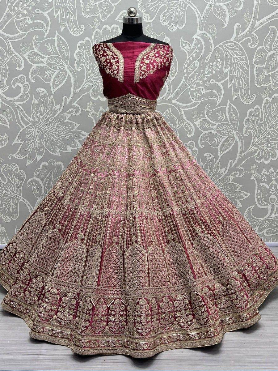 Maroon and gold embroidered lehenga choli with intricate floral patterns, perfect for Indian weddings and festive occasions.