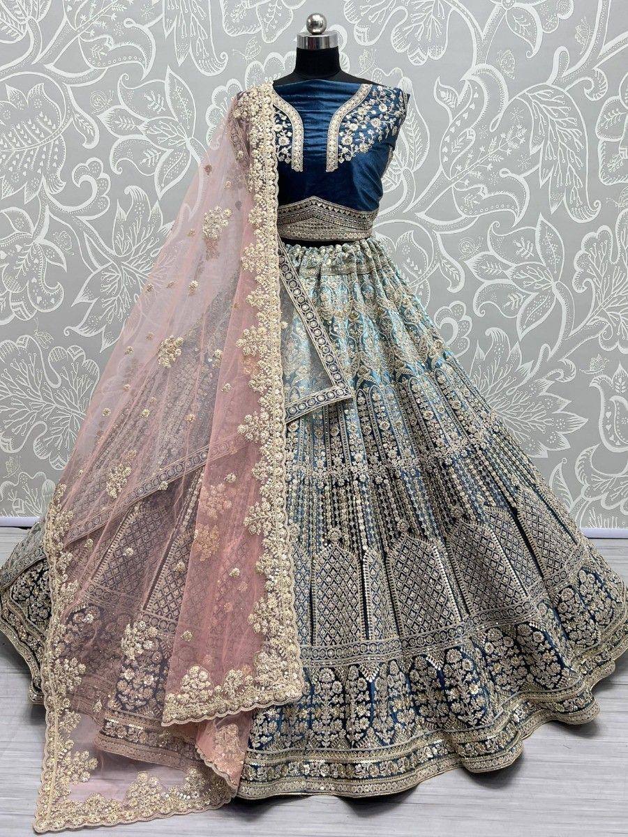 Blue and gold designer lehenga choli with floral embroidery and sheer dupatta, perfect for Indian weddings