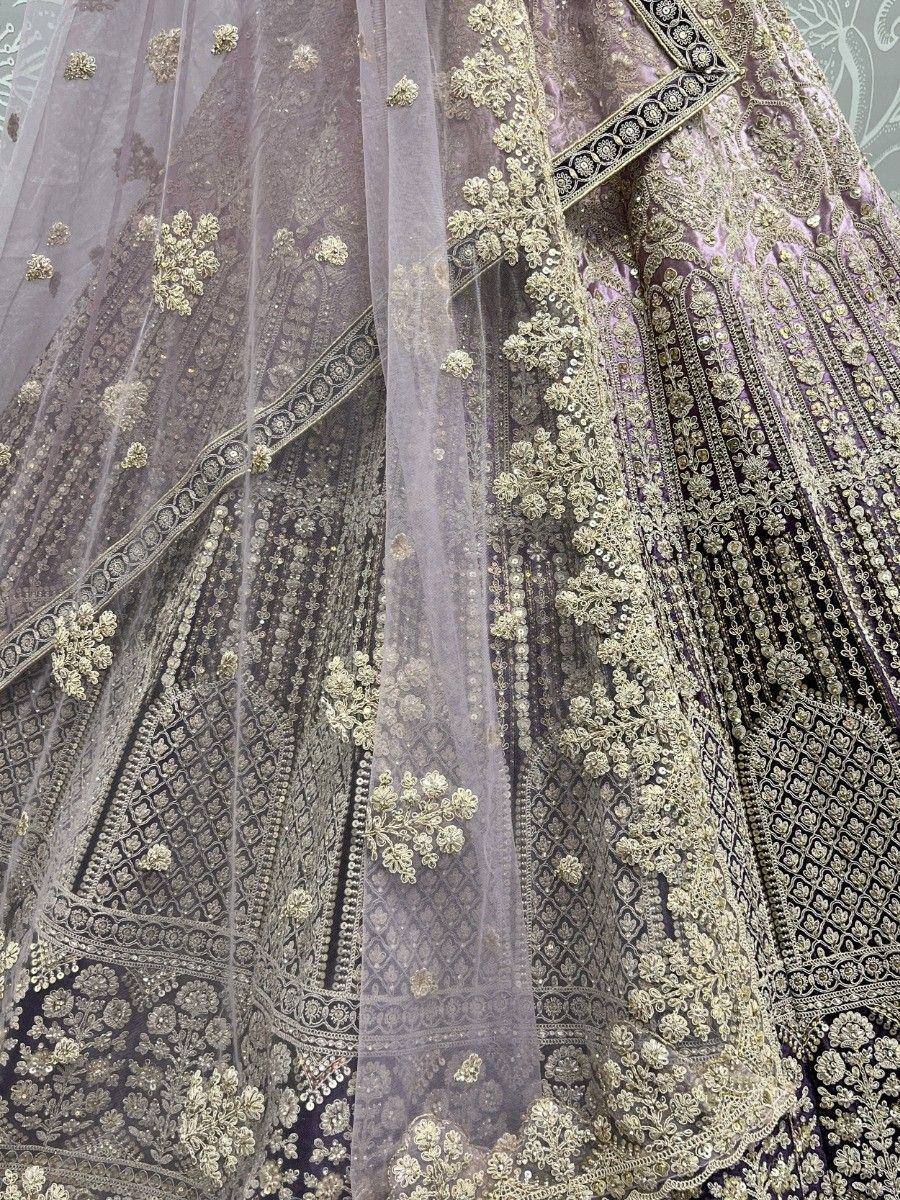 Luxury purple lehenga with gold embroidery and sheer dupatta, perfect for Indian weddings and ethnic events.