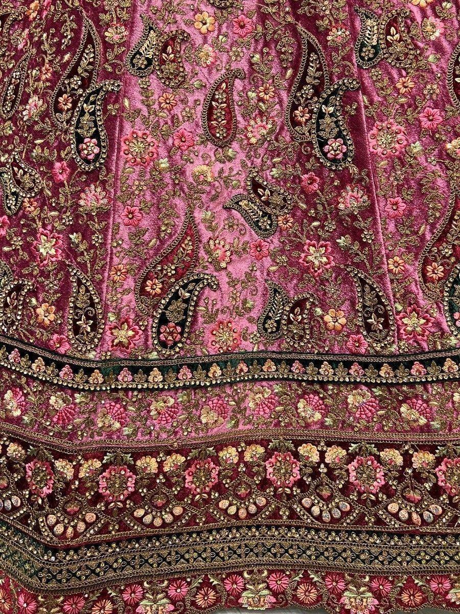Pink velvet ethnic gown with gold floral and paisley embroidery, perfect for Indian weddings and festivals.