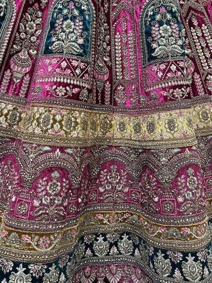 Luxury Indian lehenga with intricate floral embroidery in pink, blue, and gold velvet fabric