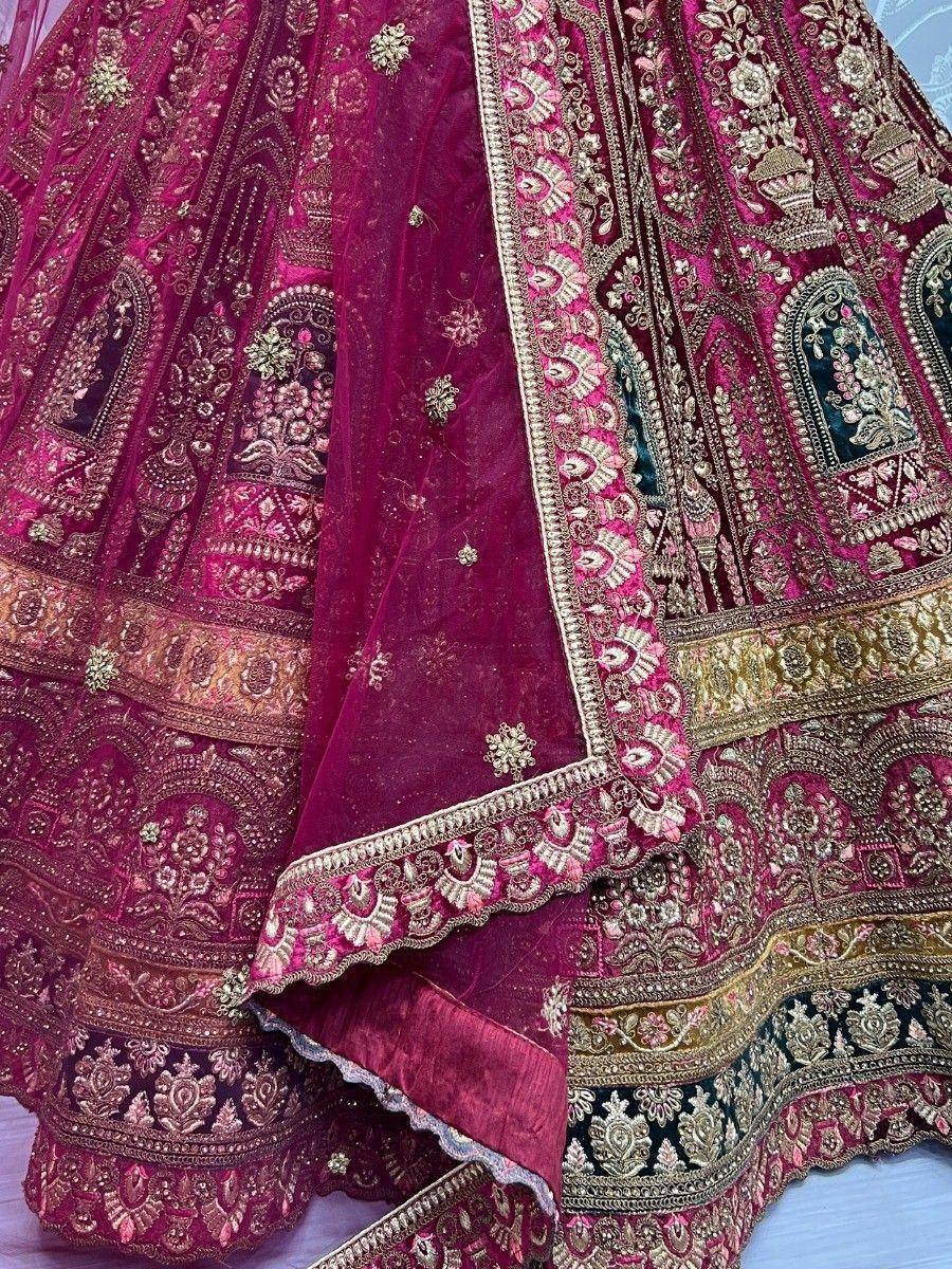 Luxury maroon lehenga choli with intricate gold embroidery and velvet fabric, perfect for Indian weddings and festive occasions.