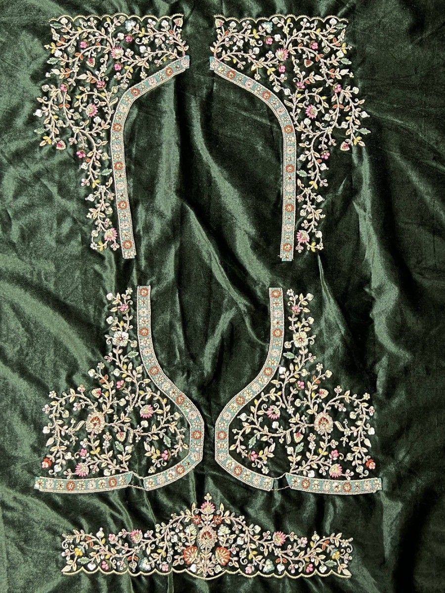 Designer embroidered lehenga choli blouse pieces with floral motifs on green velvet
