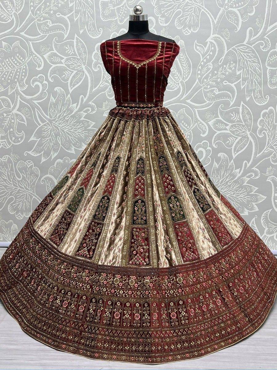 Maroon velvet lehenga choli with gold embroidery and floral motifs, perfect for Indian weddings and festive occasions.
