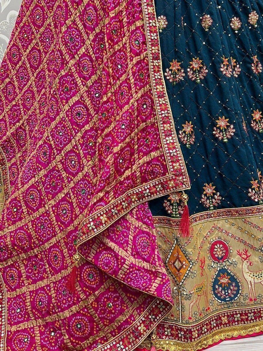 Pink and navy blue embroidered lehenga choli with mirror work and deer motifs, perfect for Indian ethnic wear.