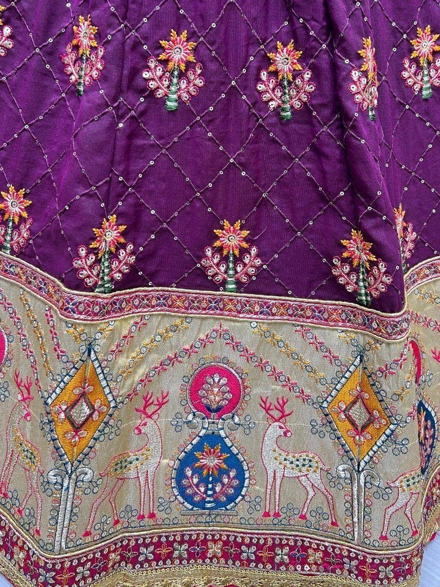 Purple ethnic lehenga with floral and deer embroidery, intricate gold border, designer Indian wear