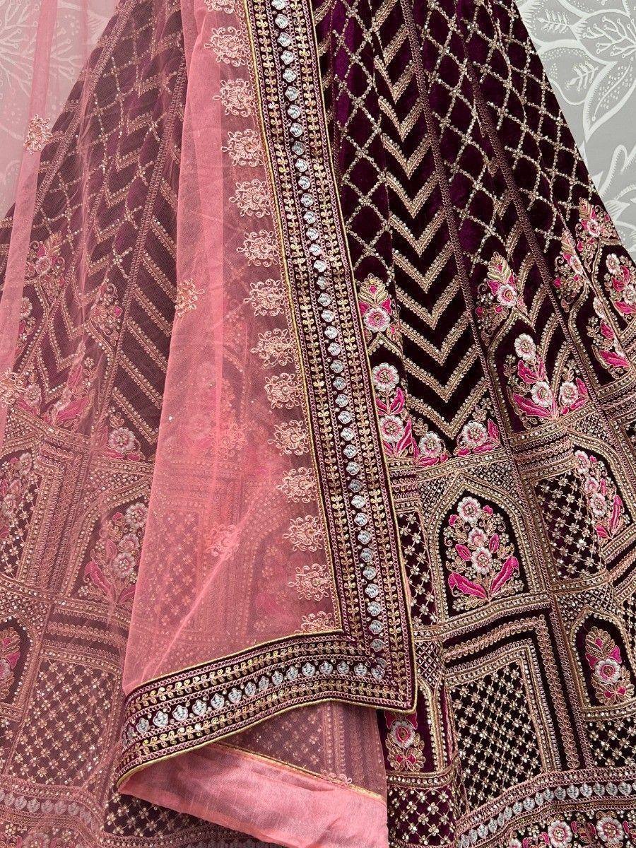 Luxury maroon velvet lehenga with pink dupatta, intricate floral embroidery and gold detailing for Indian weddings