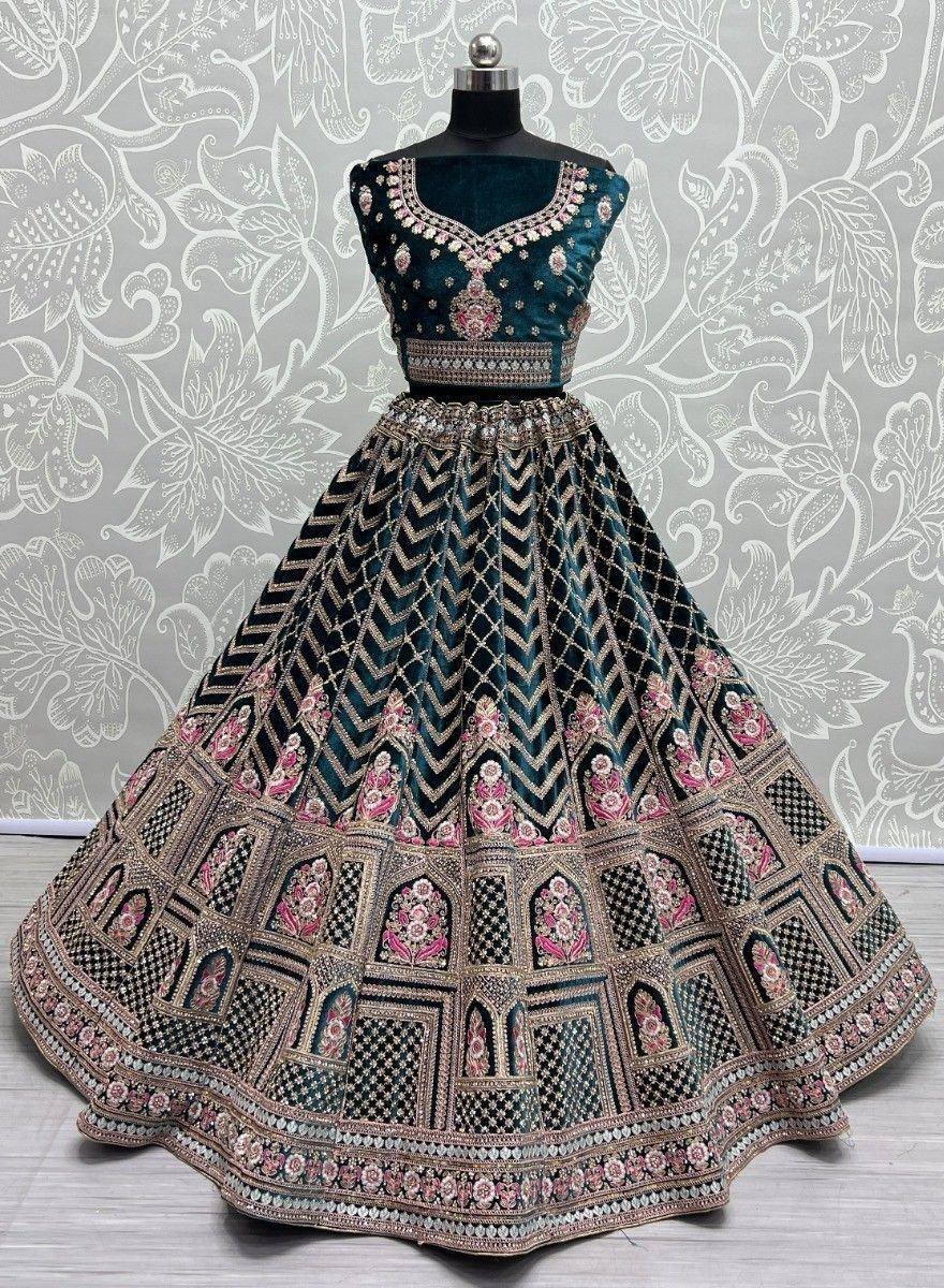 Teal velvet lehenga choli with pink floral embroidery and geometric patterns, ideal for Indian ethnic wear occasions