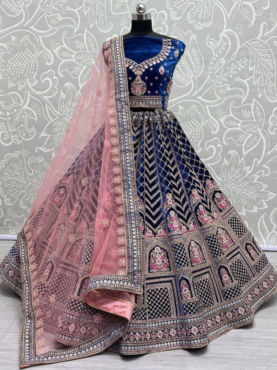 Royal blue velvet lehenga choli with intricate gold embroidery and pink dupatta, perfect for Indian weddings and festive occasions.