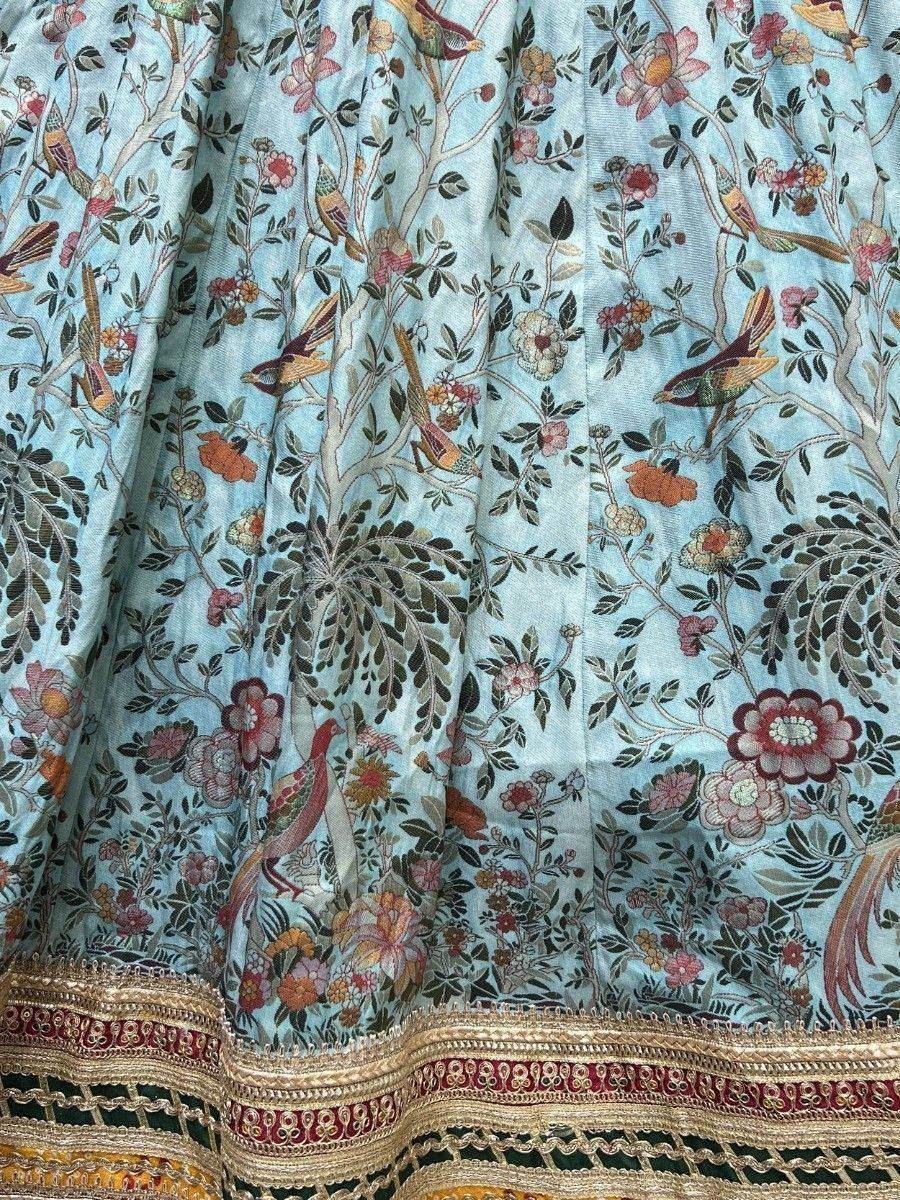 Light blue lehenga with floral bird print and gold embroidery border
