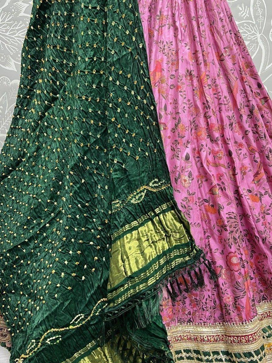 Green and pink Indian ethnic sarees with floral prints and gold embroidery, perfect for festive occasions.