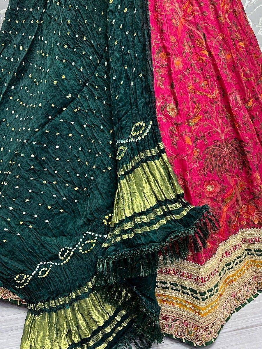 Green and pink embroidered lehenga choli with gold detailing and tassels, ethnic Indian wear