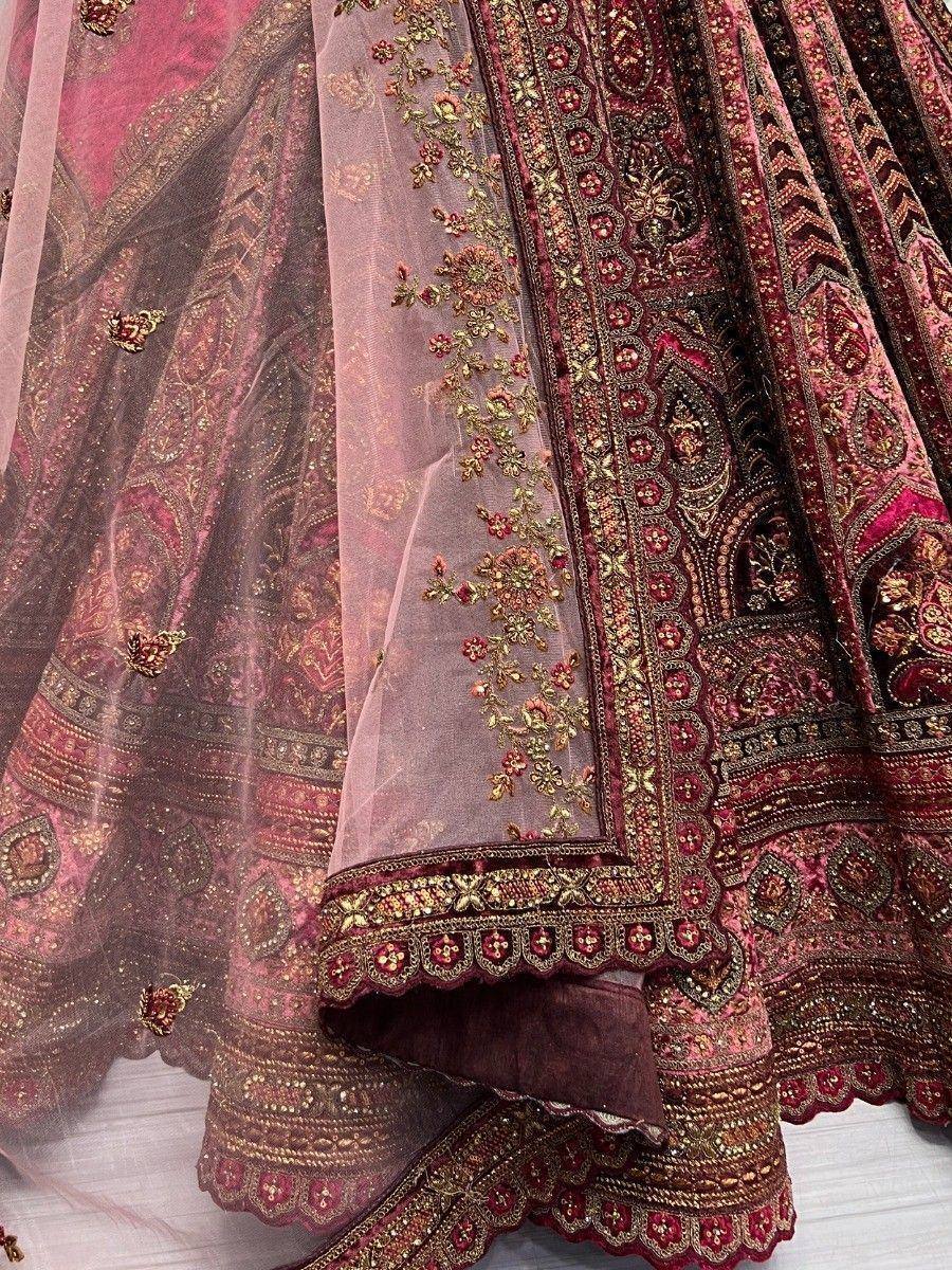 Luxury maroon lehenga choli with gold embroidery and sheer dupatta, perfect for Indian weddings and festive occasions