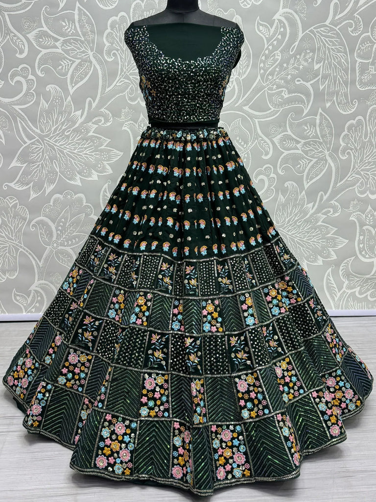 Emerald green designer lehenga choli with floral embroidery and sequin work, perfect for weddings and festivals.