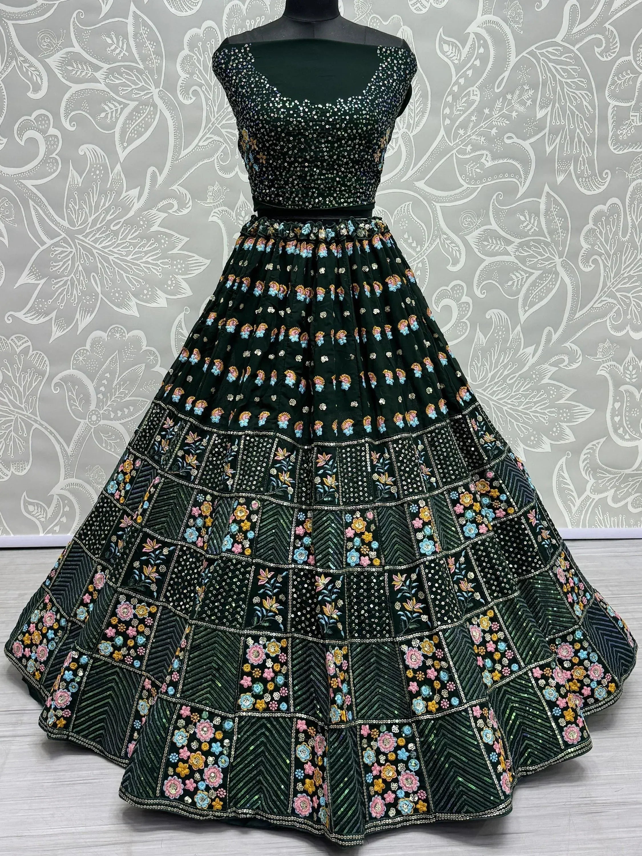 Emerald green designer lehenga choli with floral embroidery and sequin work, perfect for weddings and festivals.