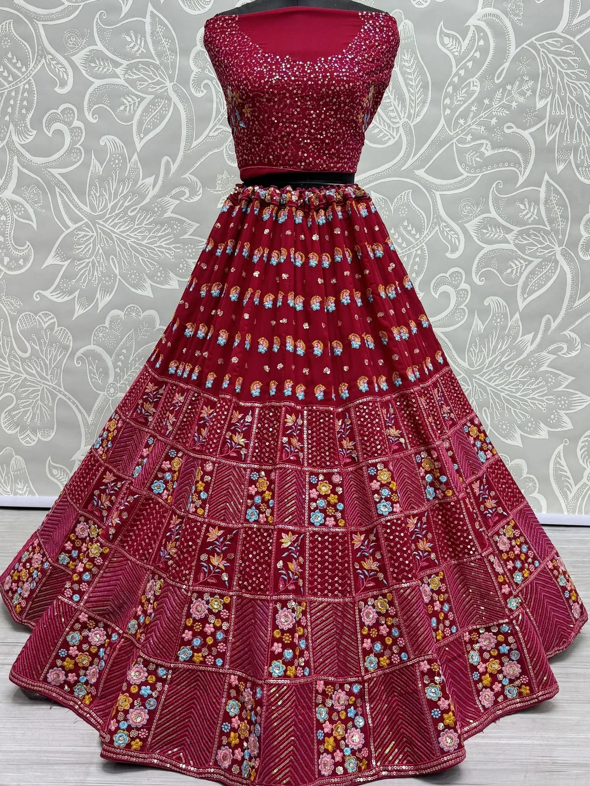 Maroon embroidered lehenga choli with floral motifs and sequin work, ideal for Indian ethnic wear occasions.