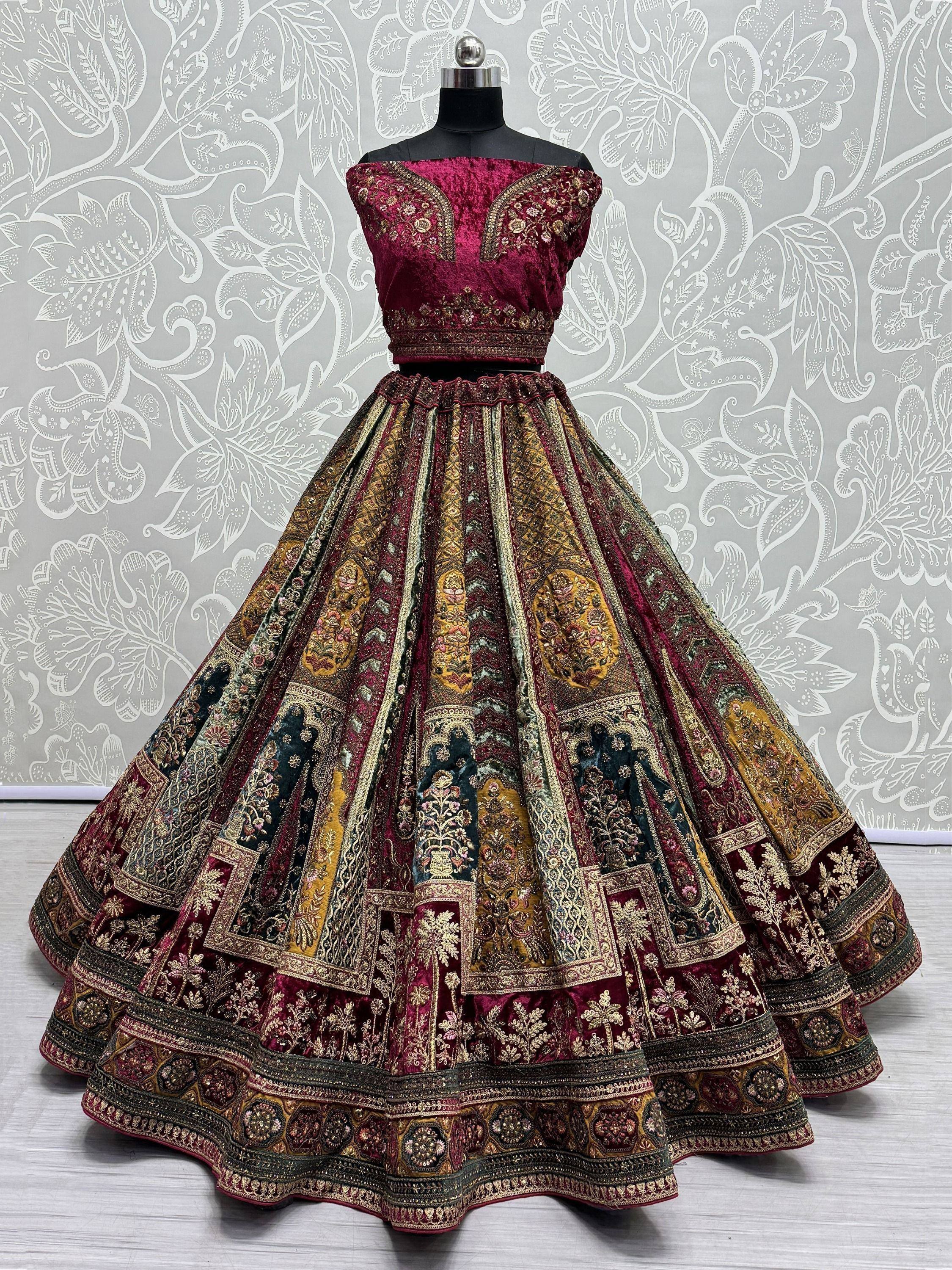 Maroon velvet designer lehenga choli with intricate gold embroidery and patchwork skirt, perfect for Indian weddings.