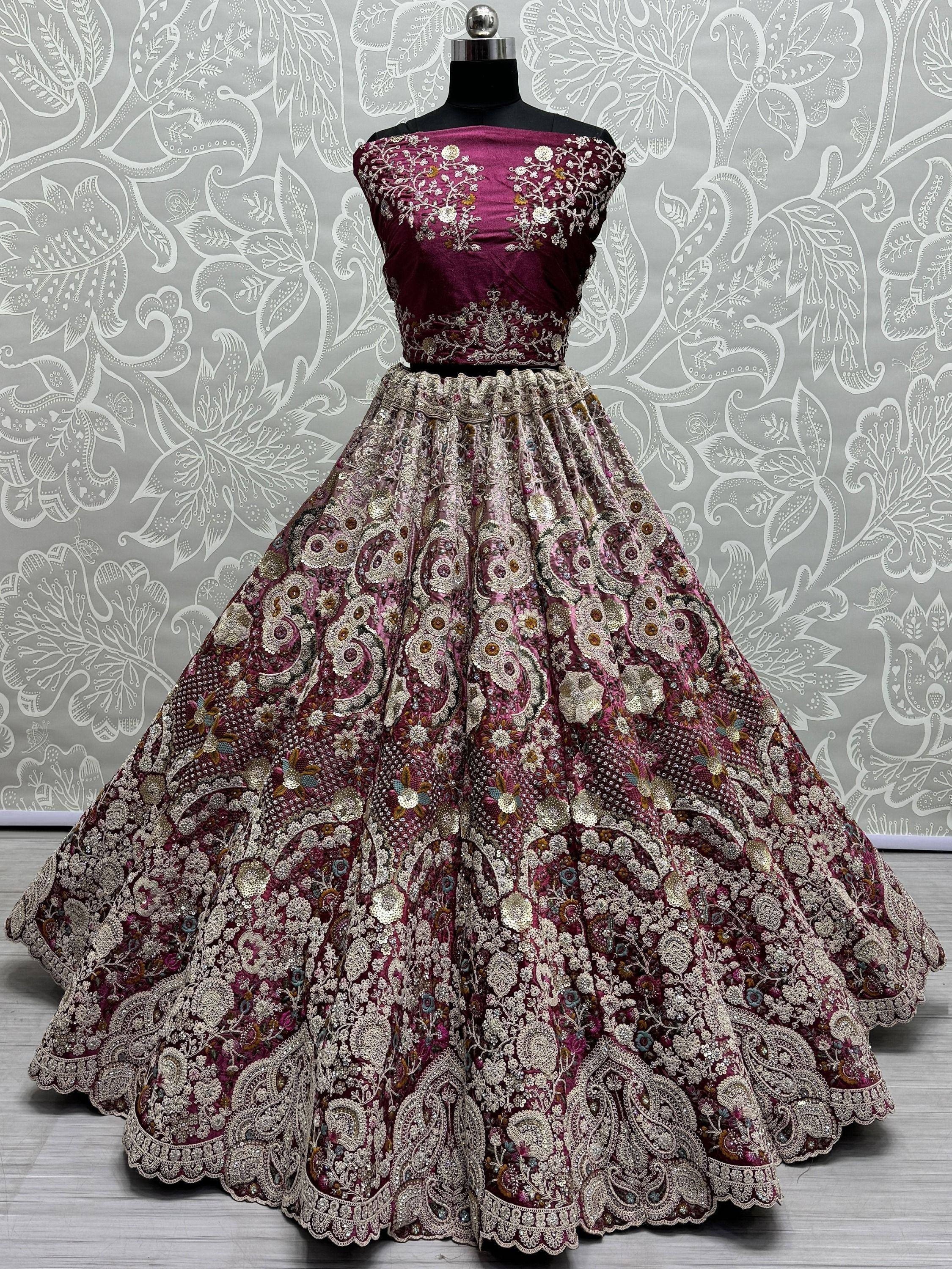 Burgundy embroidered lehenga choli with floral and paisley motifs, perfect for Indian ethnic wear occasions.