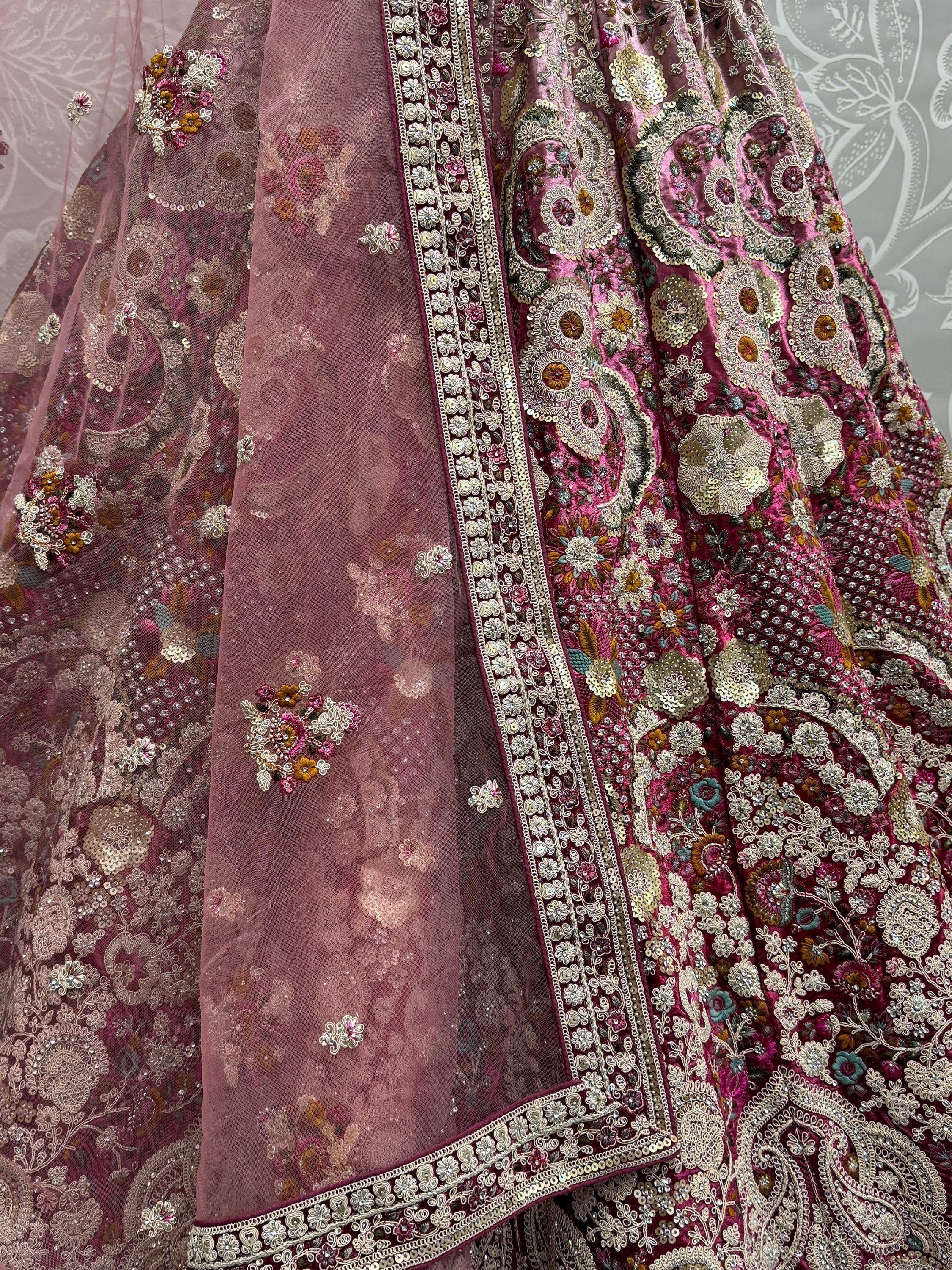 Luxury maroon lehenga choli with heavy floral embroidery, sequins, and net dupatta for Indian weddings