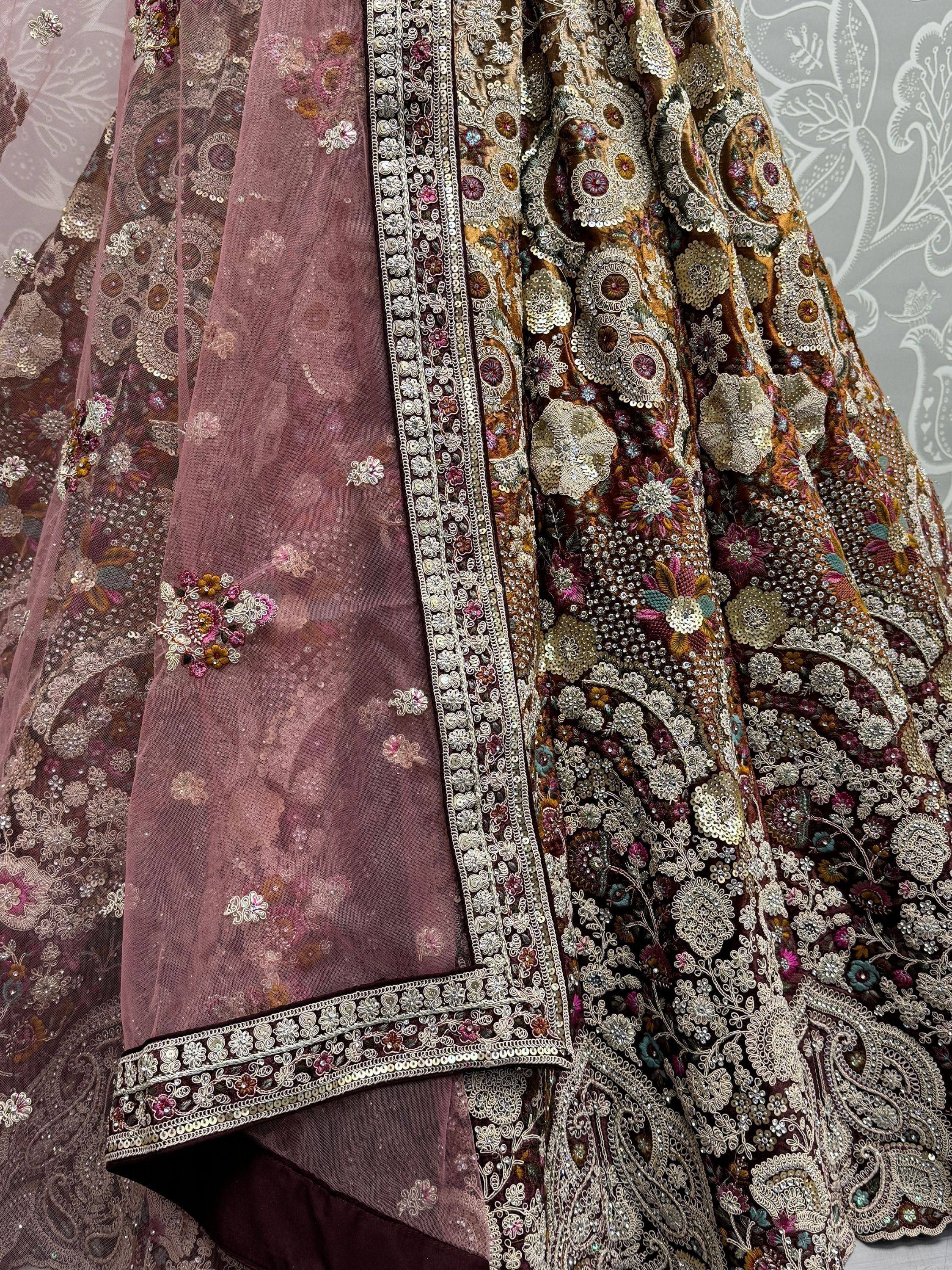 Luxury Indian lehenga choli with intricate floral embroidery and sequin work in maroon and gold tones