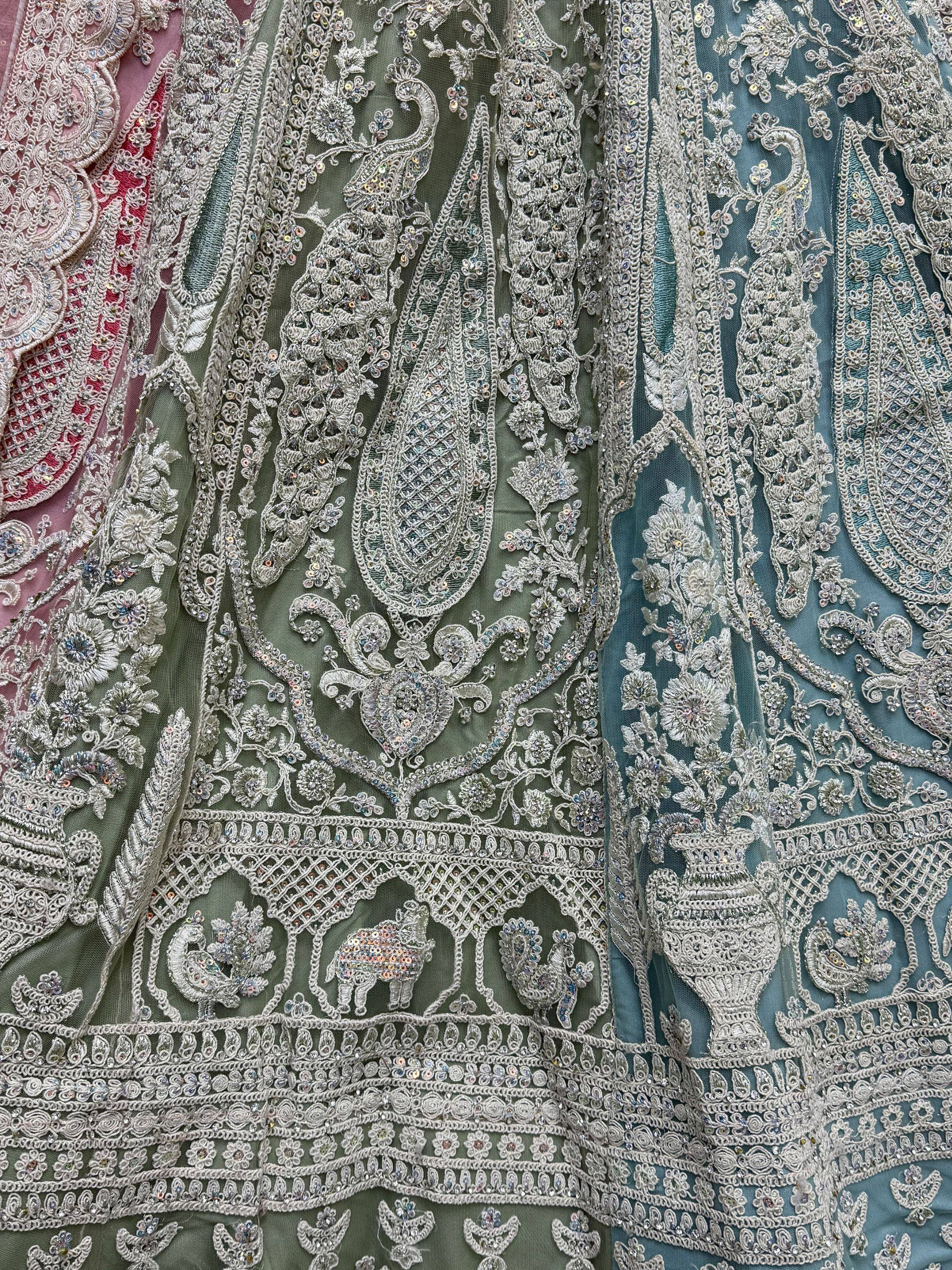 Exquisite Indian ethnic wear with intricate silver embroidery, peacock & elephant motifs on sheer fabric