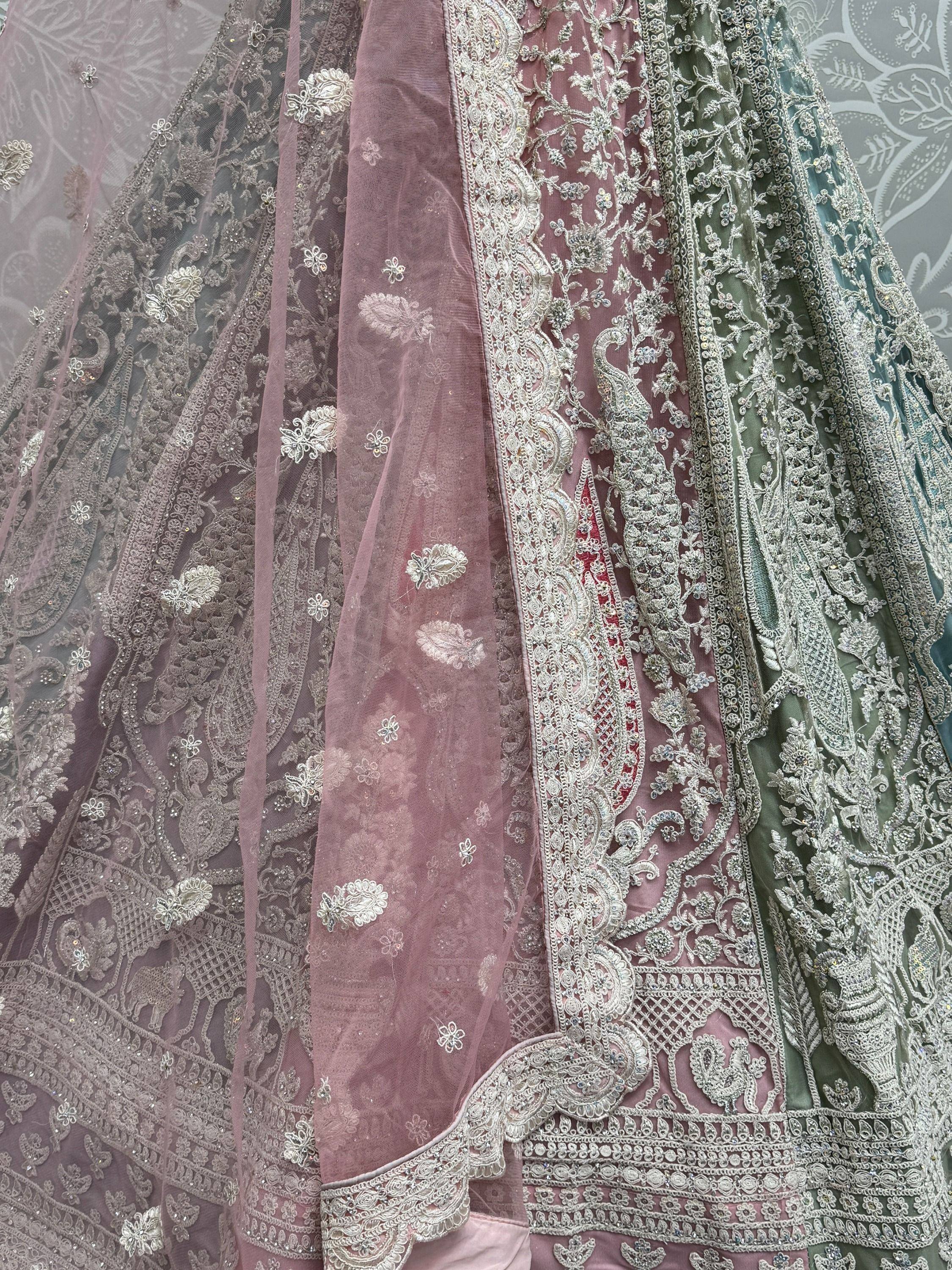 Elegant Indian lehenga choli with intricate silver embroidery, floral motifs, and sheer dupatta for festive occasions