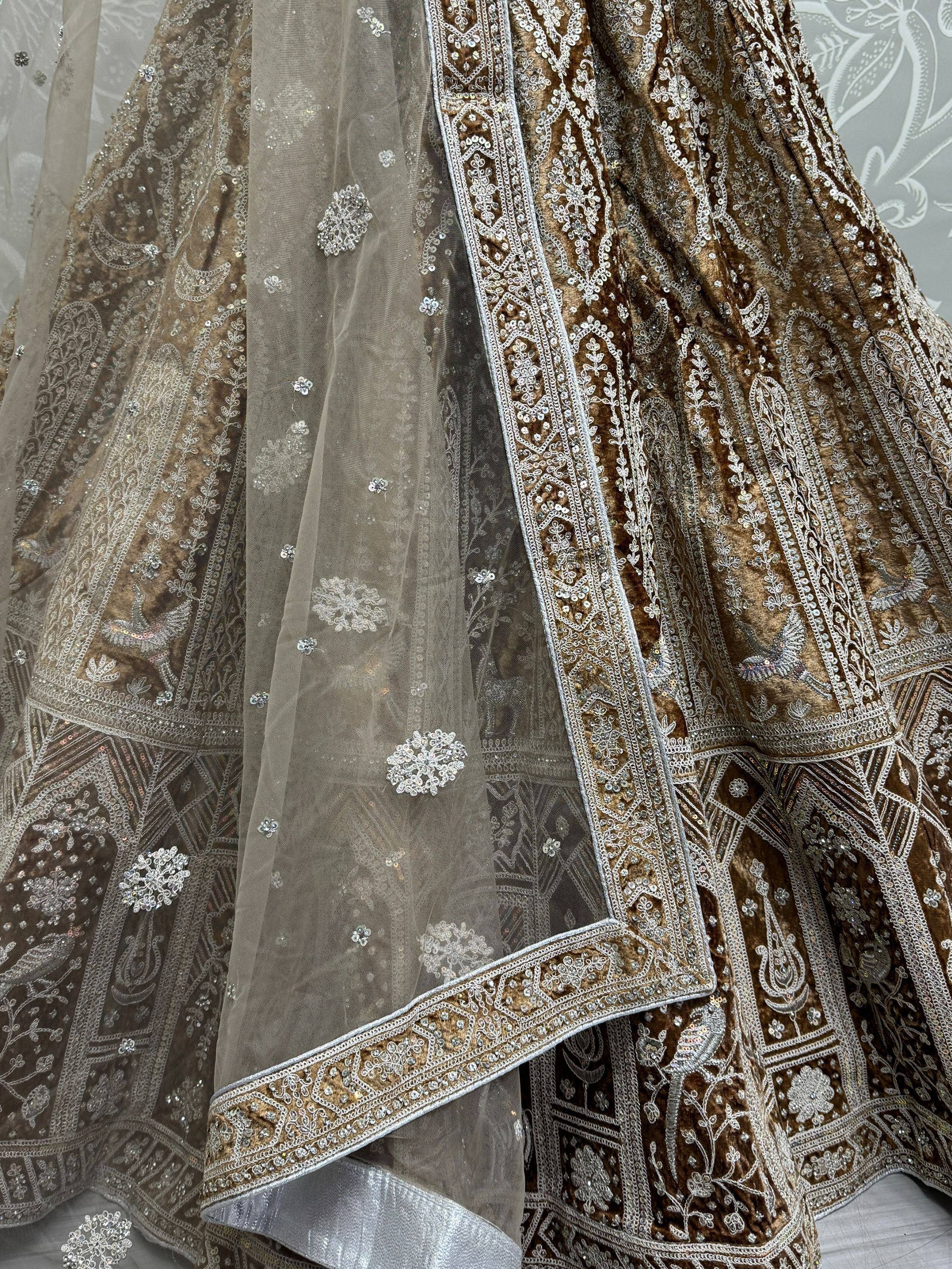 Luxury brown velvet lehenga with silver embroidery and sheer dupatta, perfect for Indian weddings and festive occasions.