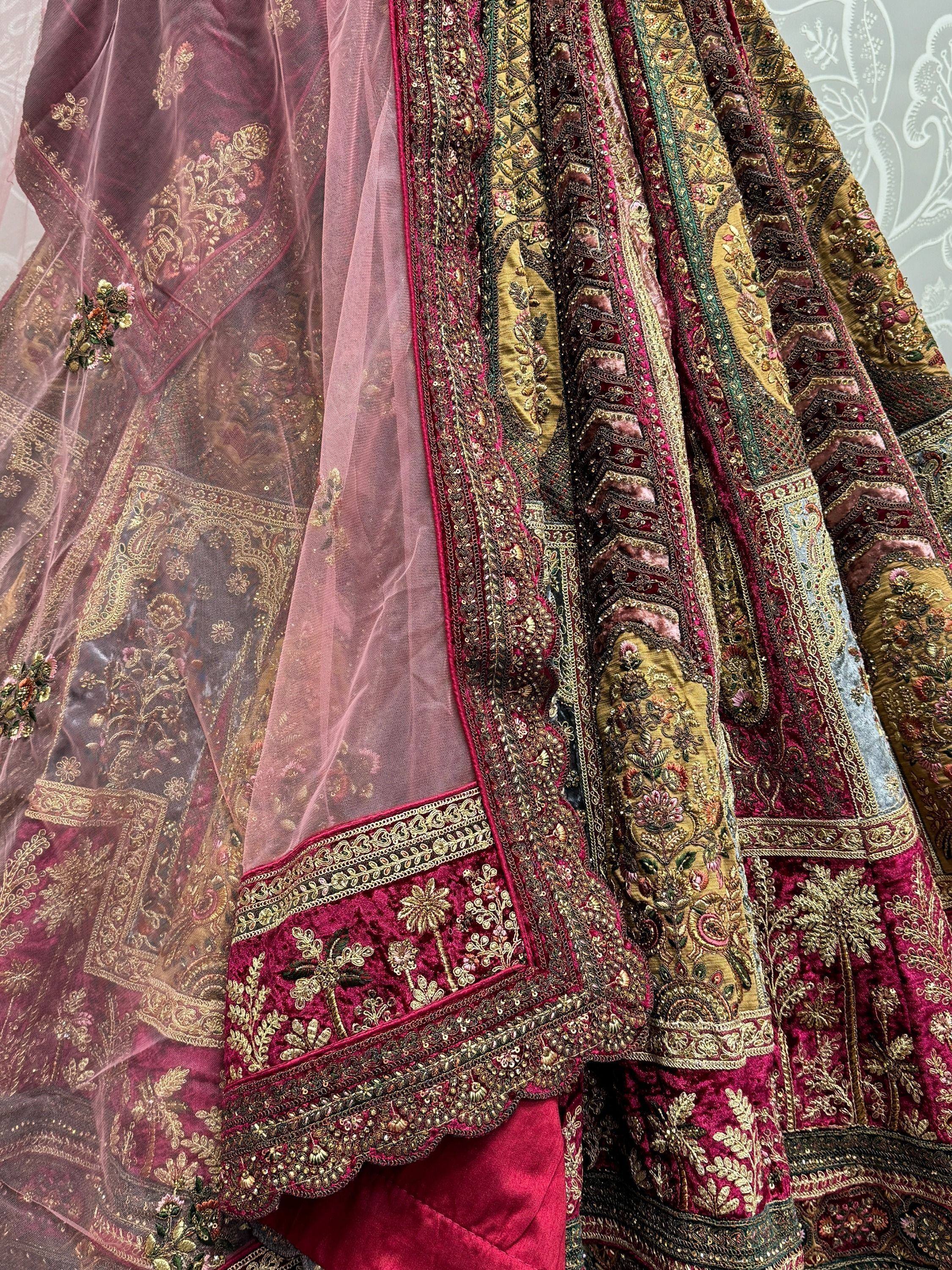 Luxury Indian lehenga choli with heavy gold embroidery, maroon velvet, and sheer dupatta for weddings
