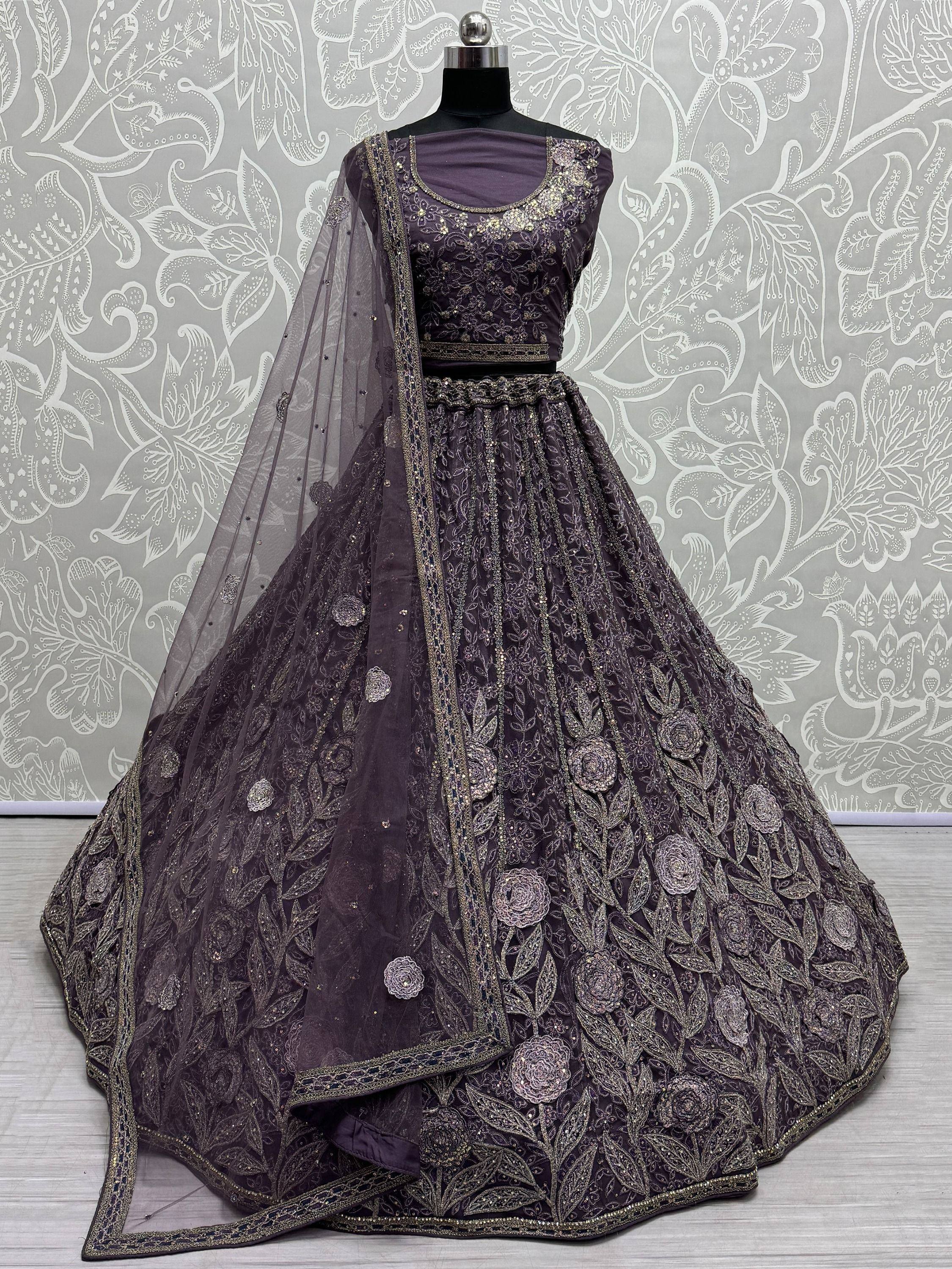 Elegant purple lehenga choli with gold floral embroidery and net dupatta, perfect for Indian weddings and festivals.