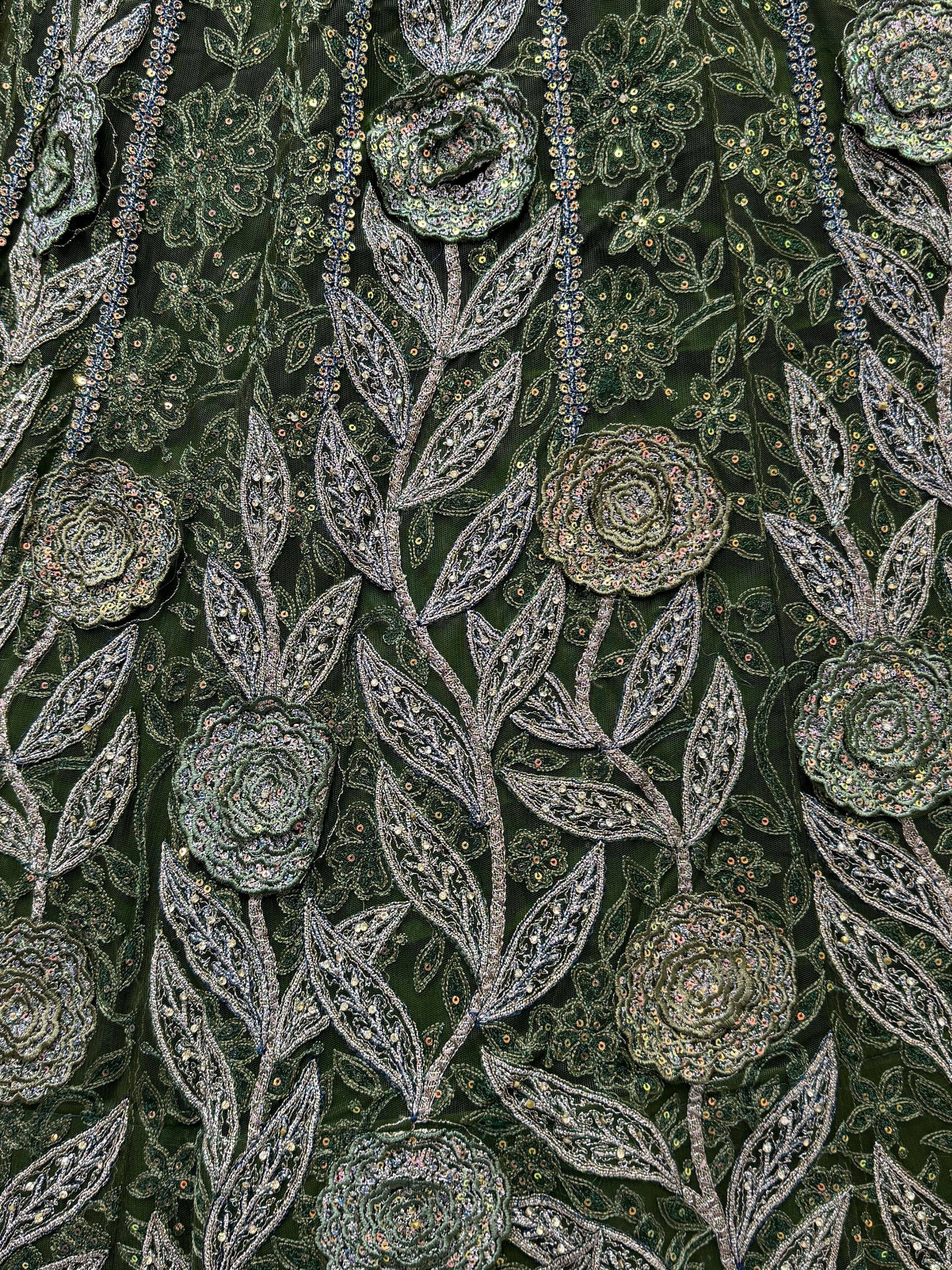 Dark green ethnic wear fabric with intricate floral embroidery and sequin detailing for lehenga or saree