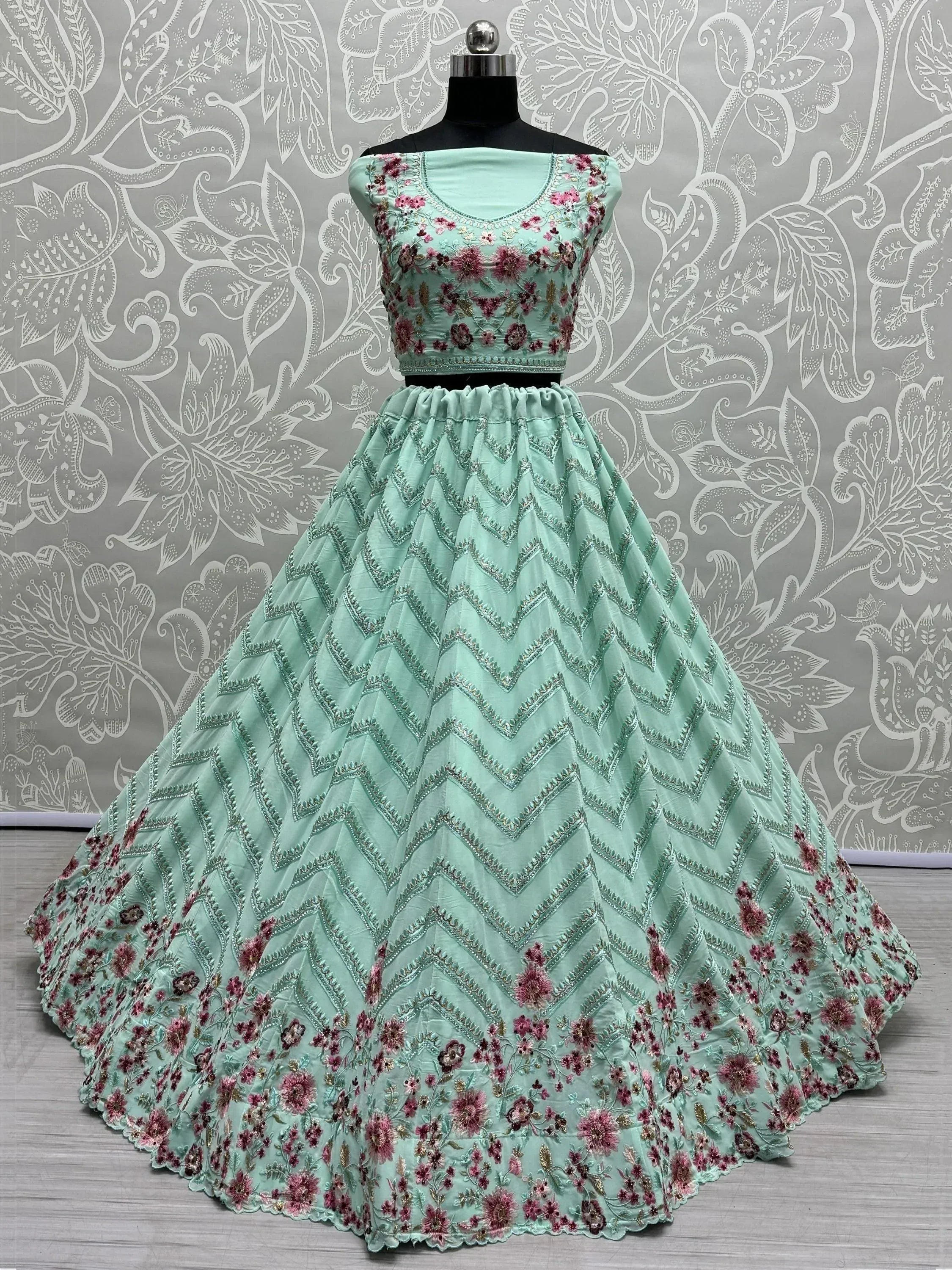 Mint green lehenga choli with floral embroidery and chevron patterns, perfect for Indian ethnic wear.