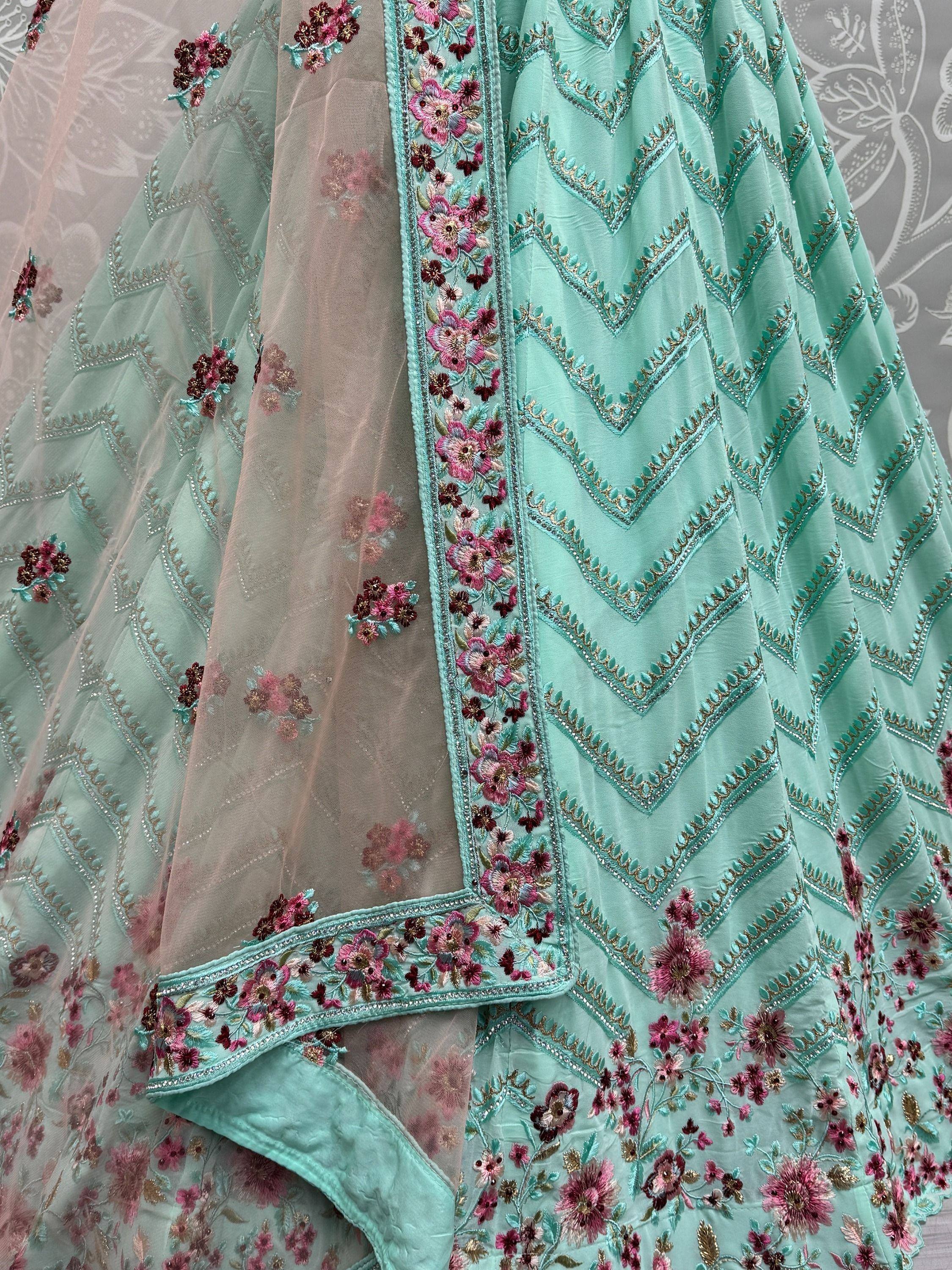Mint green lehenga choli with floral embroidery and chevron detailing, perfect for Indian ethnic wear