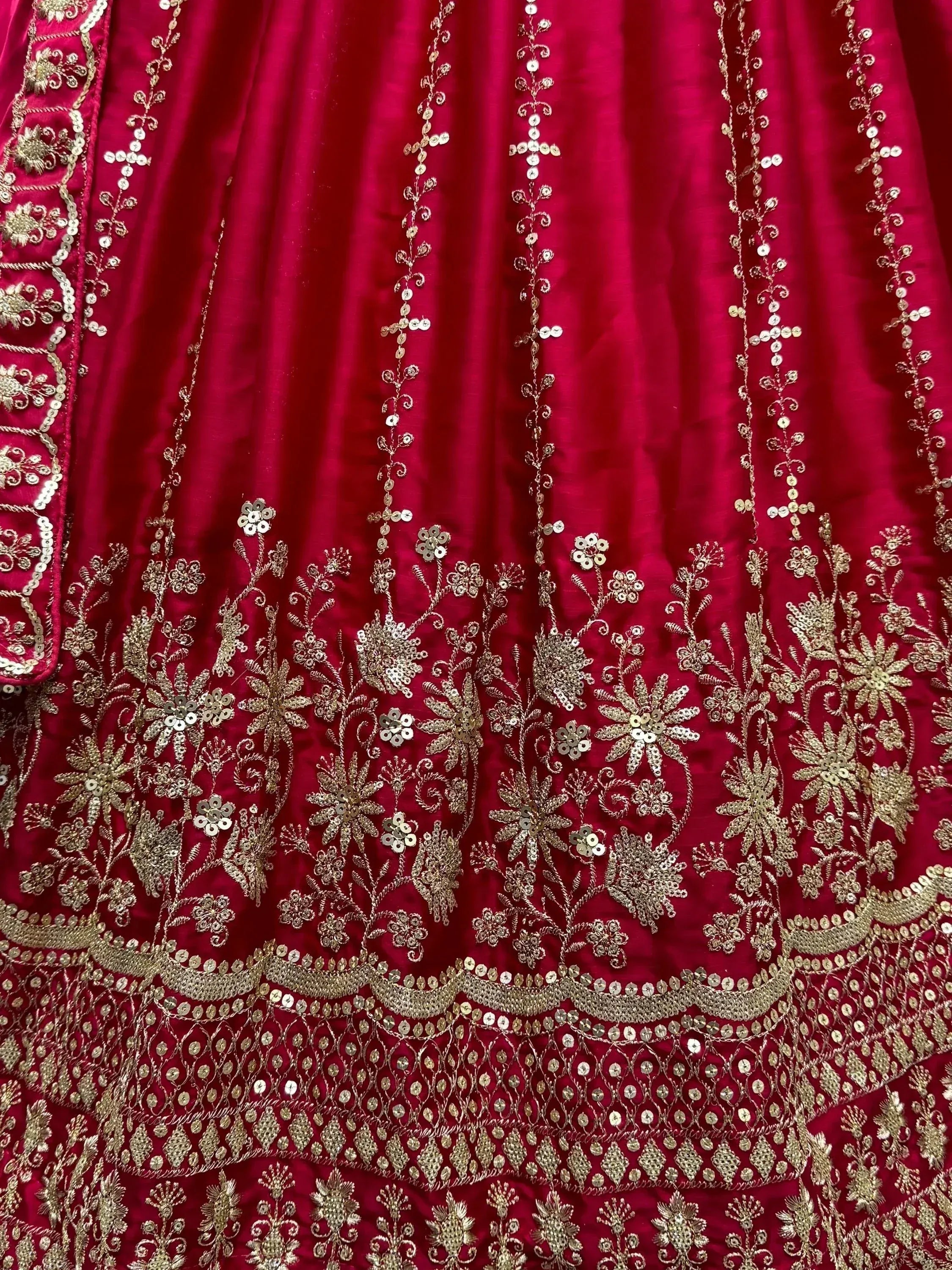 Rich red ethnic gown with gold floral embroidery and sequin detailing for festive occasions