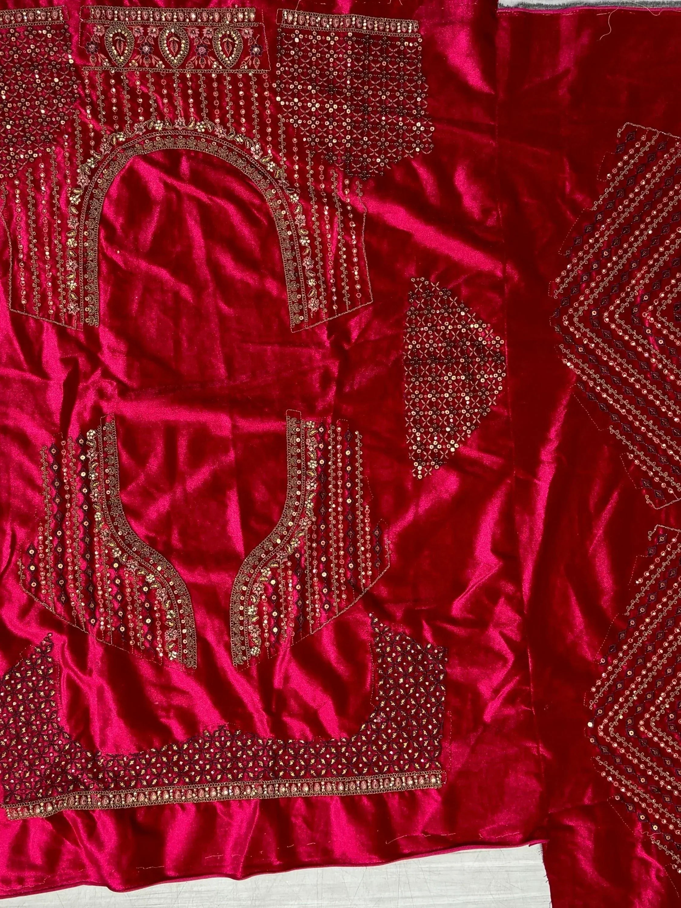 Rich red velvet ethnic wear fabric with intricate gold embroidery and sequin detailing for designer lehenga or saree