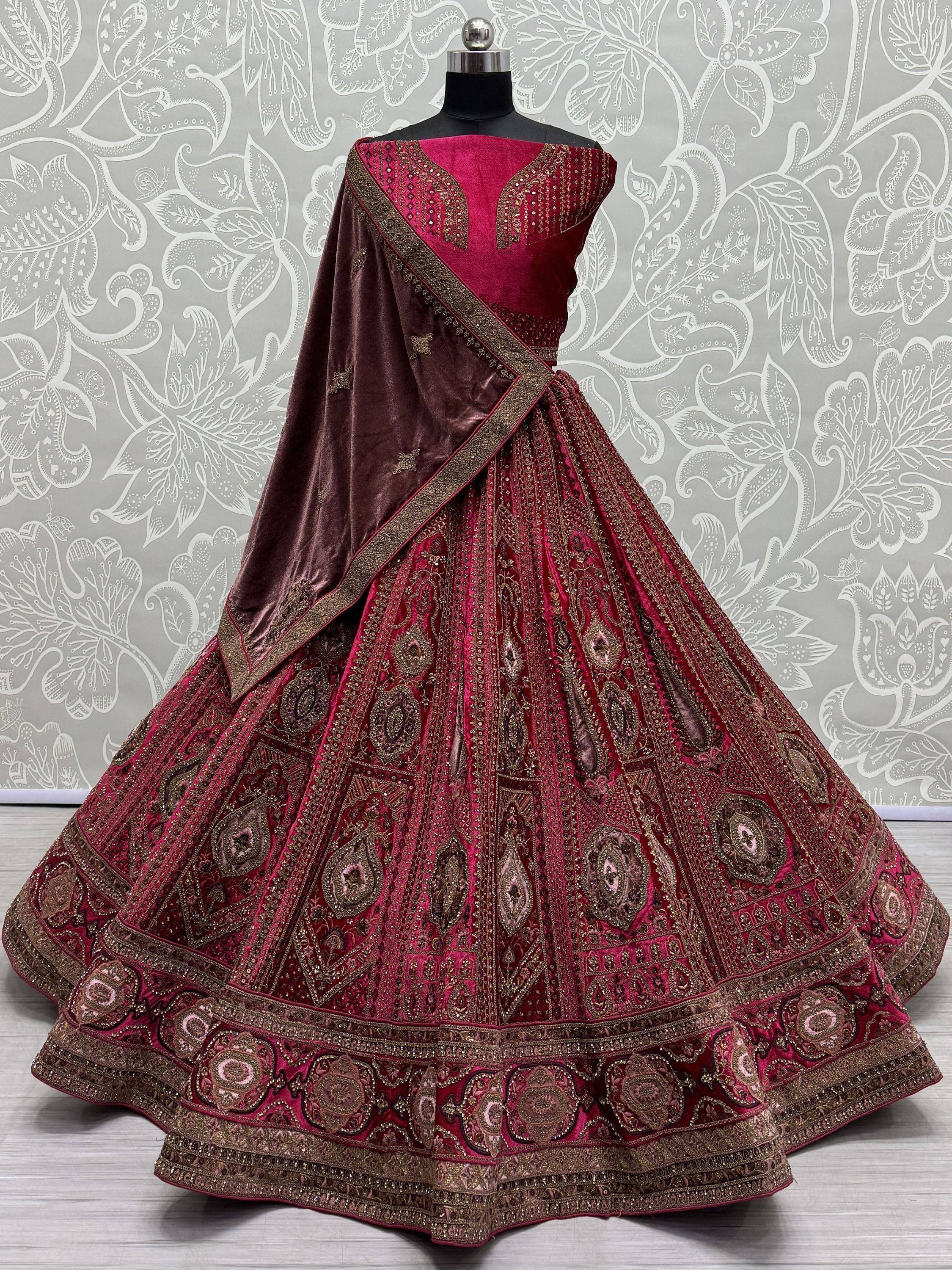 Luxury maroon velvet lehenga choli with gold embroidery, perfect for Indian weddings and festive occasions.