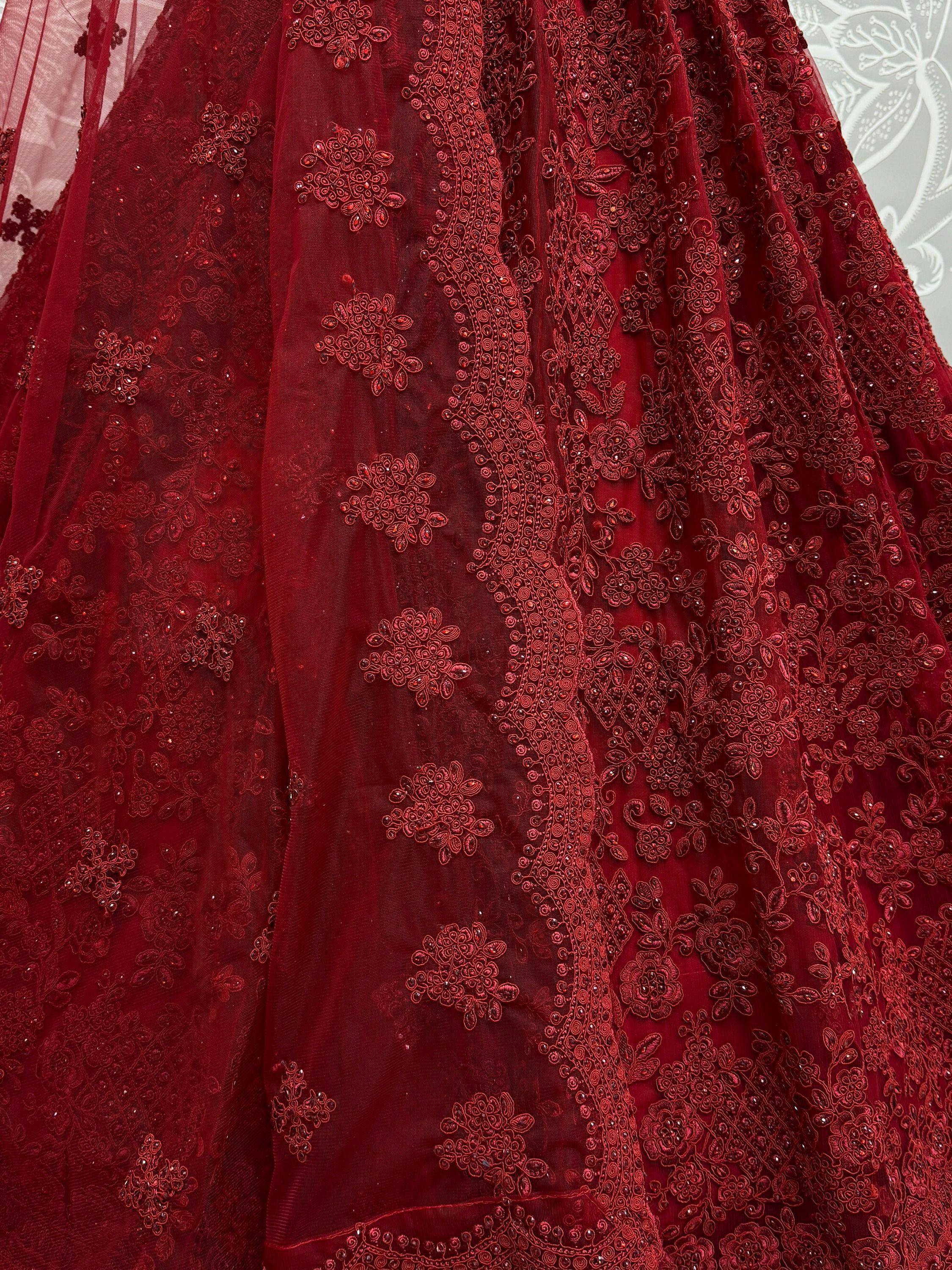 Rich maroon lehenga with intricate floral embroidery and beadwork, perfect for Indian ethnic occasions.