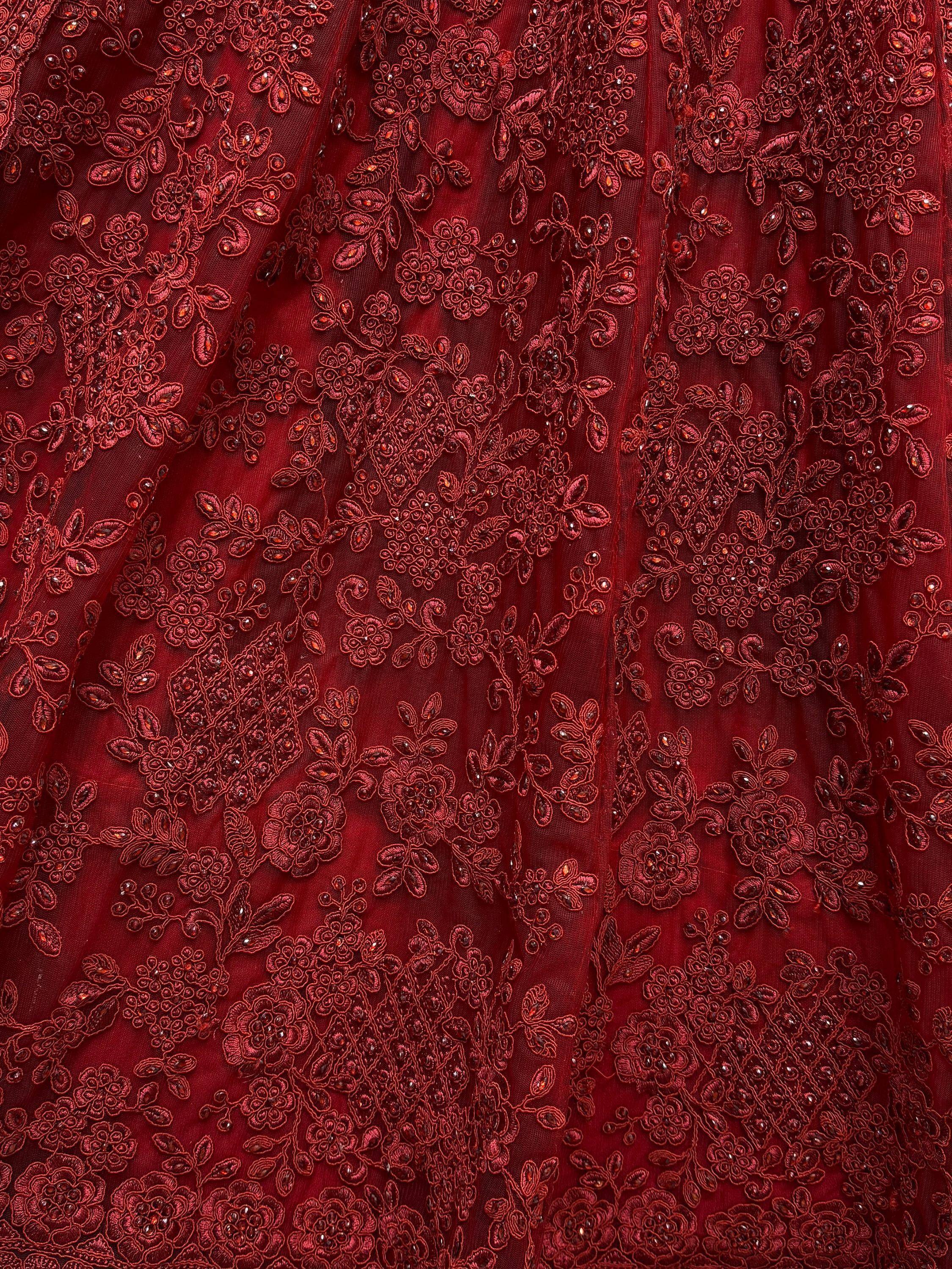 Rich maroon ethnic wear fabric with intricate floral embroidery and beadwork details