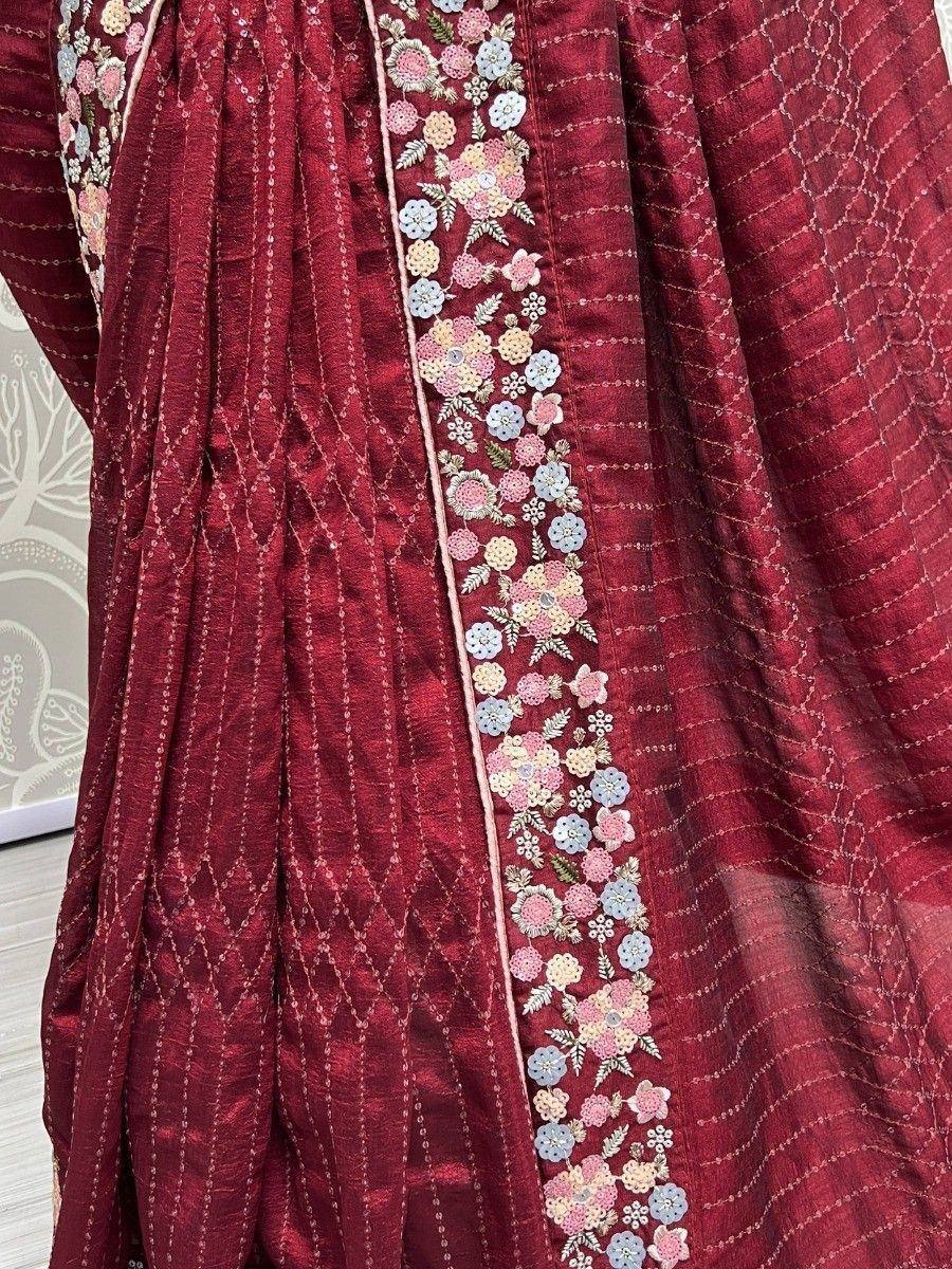 Maroon ethnic gown with floral embroidery and sequin detailing, perfect for Indian festive wear.