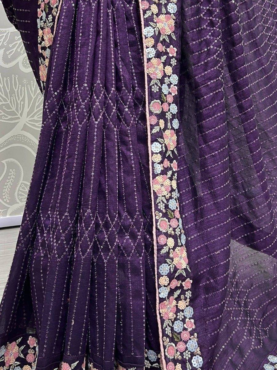Purple ethnic gown with floral embroidery and geometric threadwork, perfect for Indian occasions.