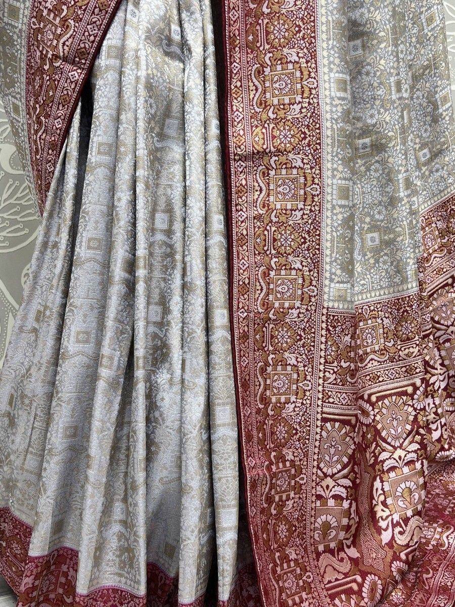 Elegant silver and maroon designer saree with intricate paisley and geometric patterns, perfect for ethnic occasions.