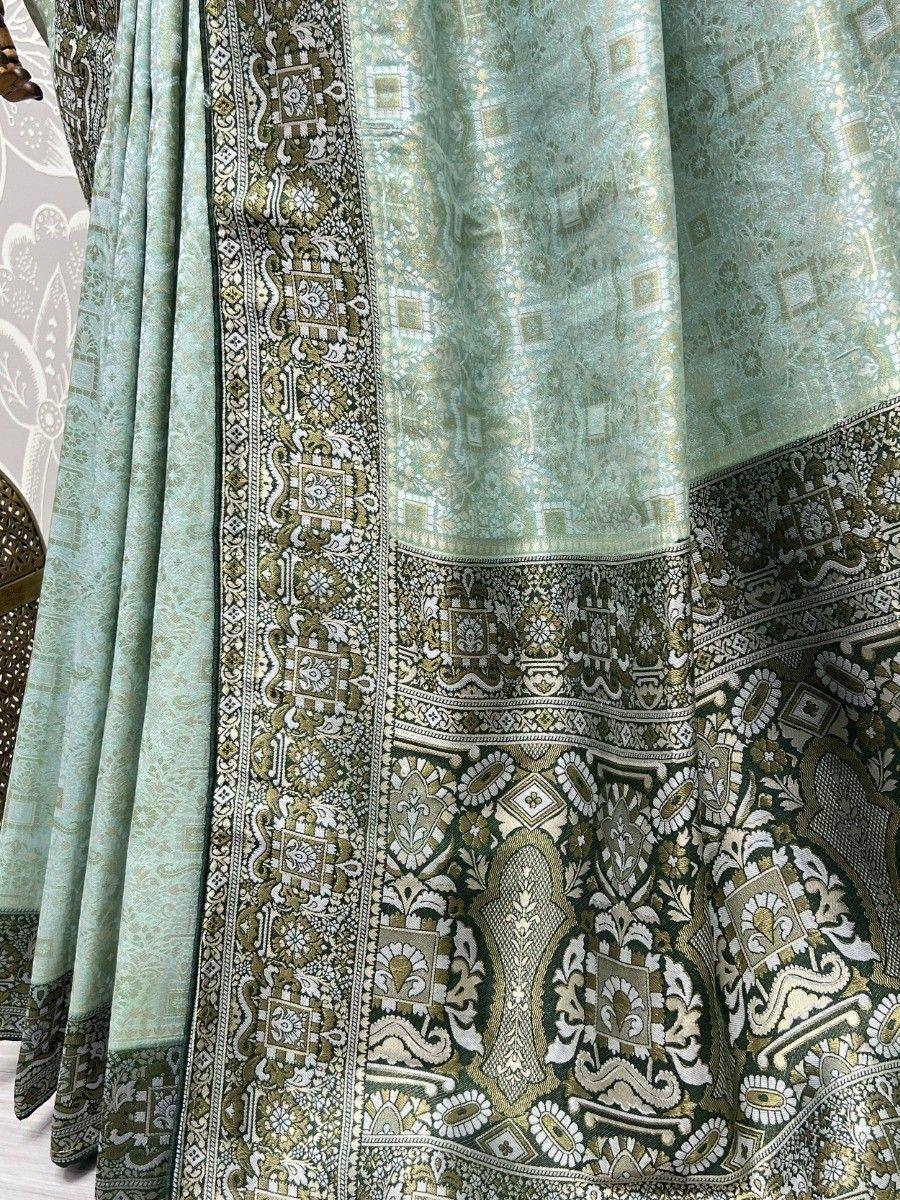 Mint green designer lehenga with intricate gold and black embroidery, perfect for Indian ethnic wear.